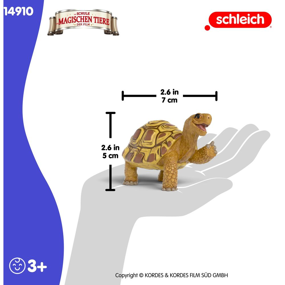 Żółta figurka żółwia z brązowymi plamami na skorupie.