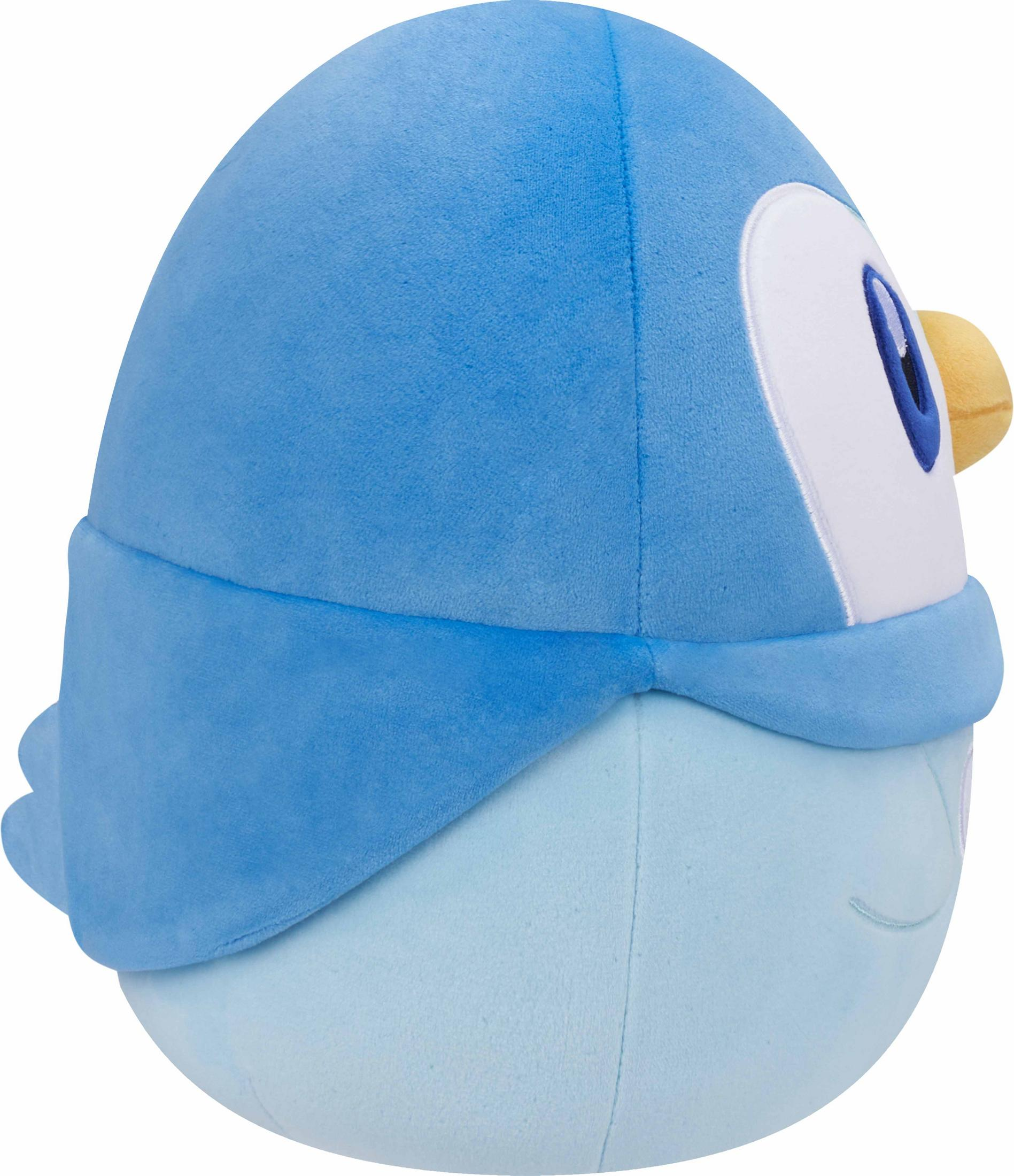 Ein blauer Plüschvogel mit weißem Gesicht und gelbem Schnabel.