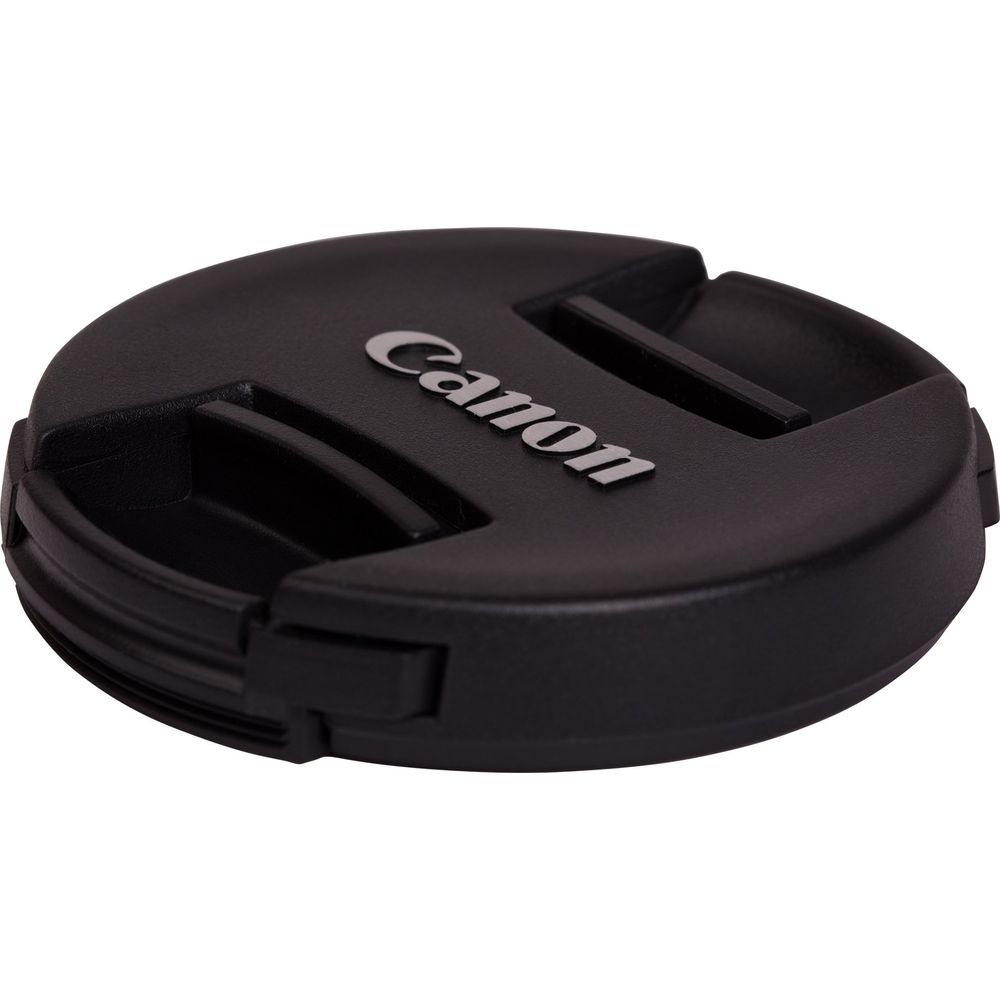 Viene mostrato in dettaglio un tappo obiettivo Canon nero con il logo Canon.