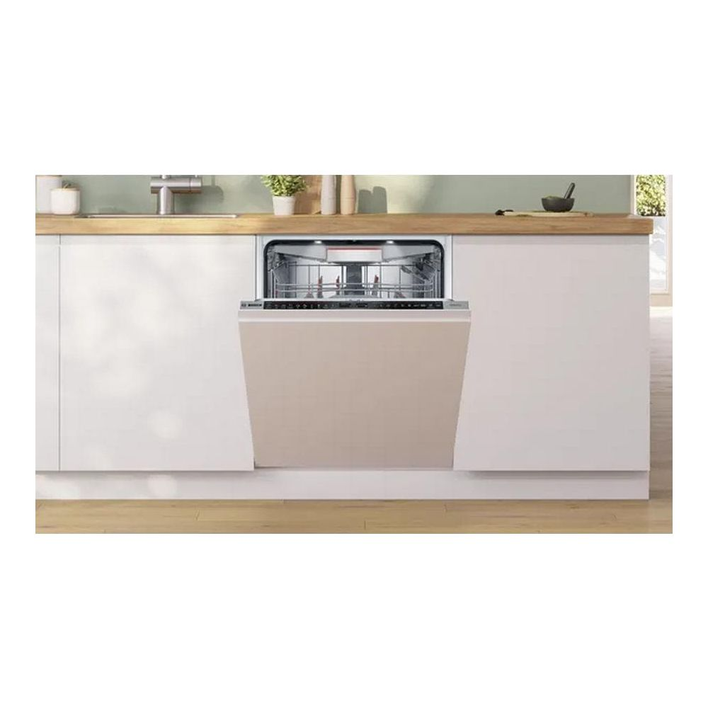 Un lavavajillas abierto con frontal beige en una cocina moderna.