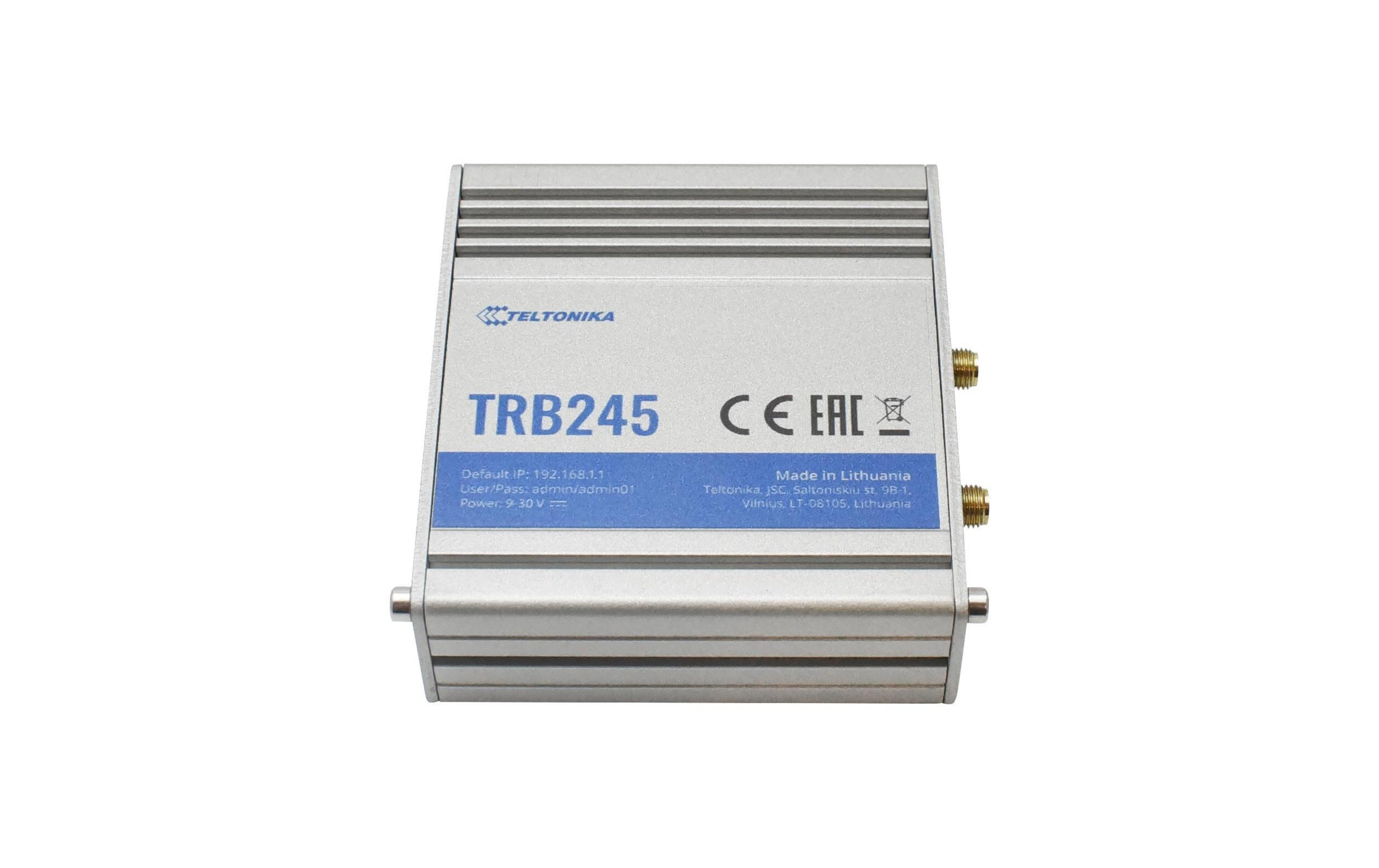 Zilveren Teltonika TRB245 apparaat met blauwe labels en connectoren.
