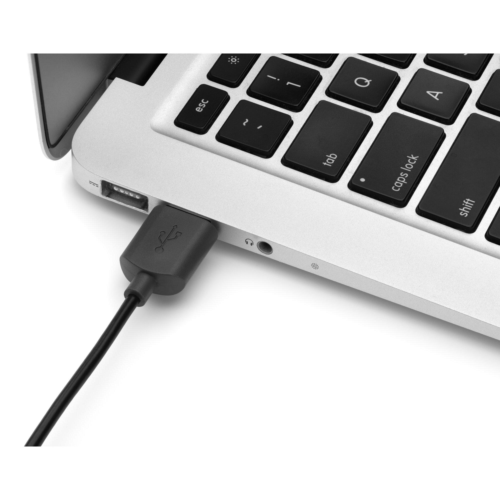 A black USB cable is plugged into the left port of a silver laptop.