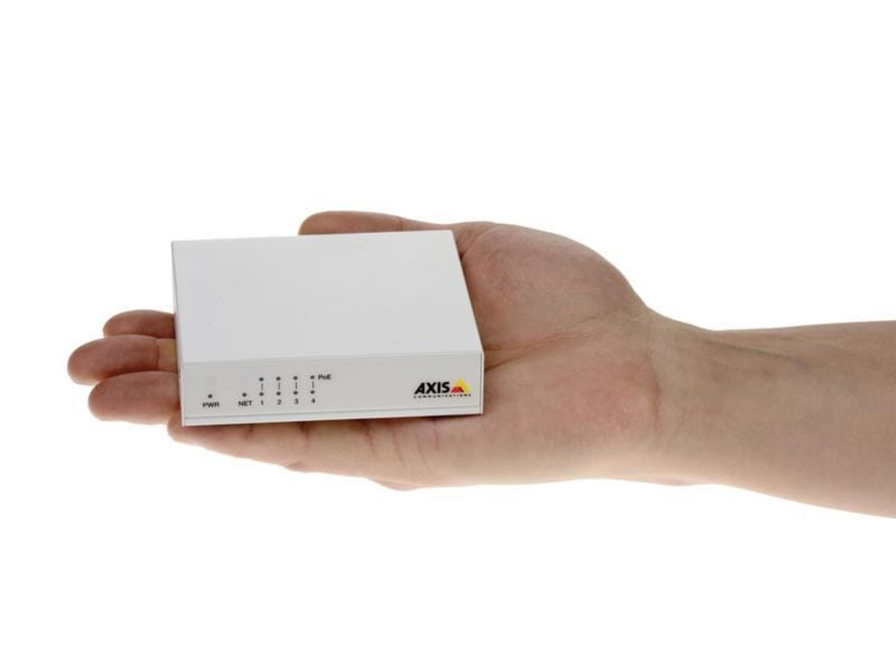 Dłoń trzyma małe białe urządzenie Axis z portami i diodami LED.