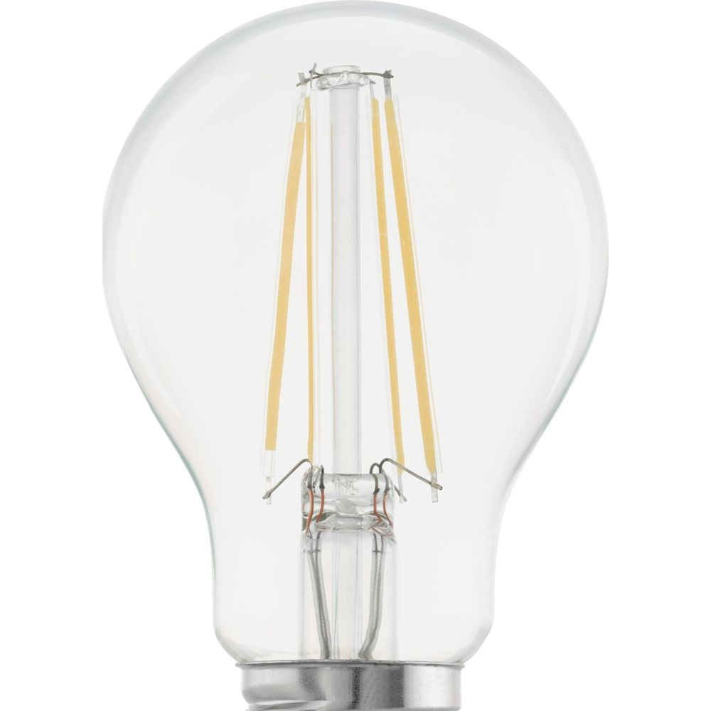 Gros plan d'une ampoule LED transparente avec filaments visibles et culot métallique.