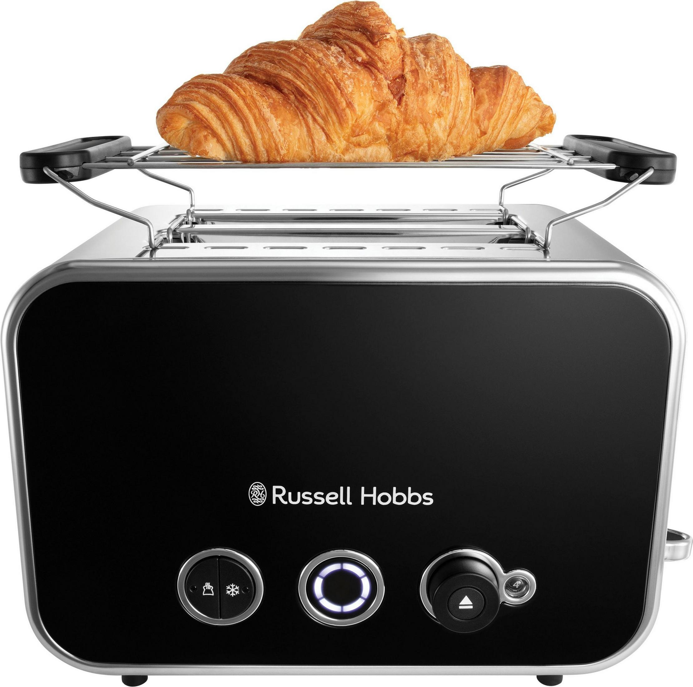Un croissant doré sur un réchauffe-croissants au-dessus d'un grille-pain noir.