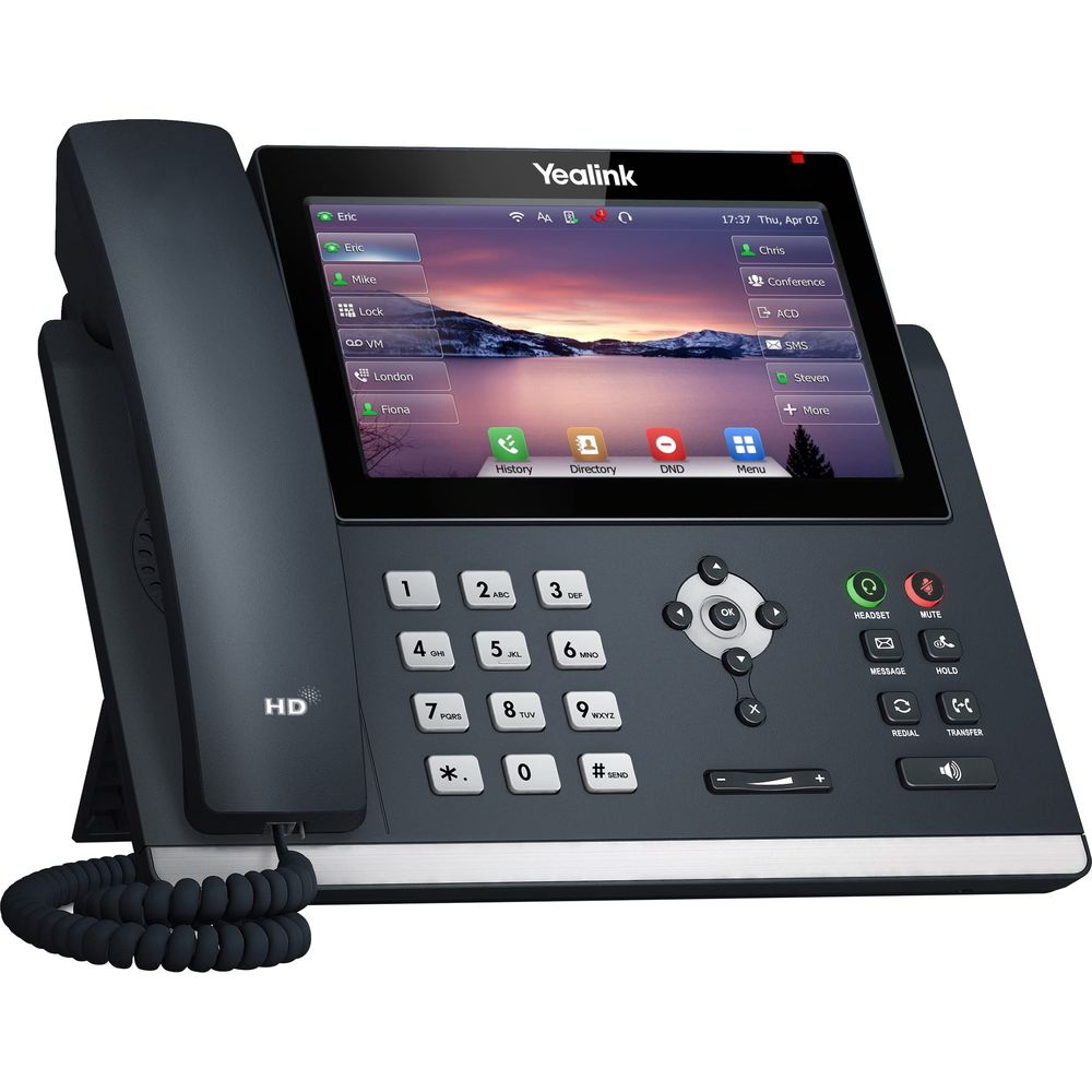 Un teléfono de escritorio Yealink con pantalla táctil, teclado y auricular. Muestra contactos y fondo.
