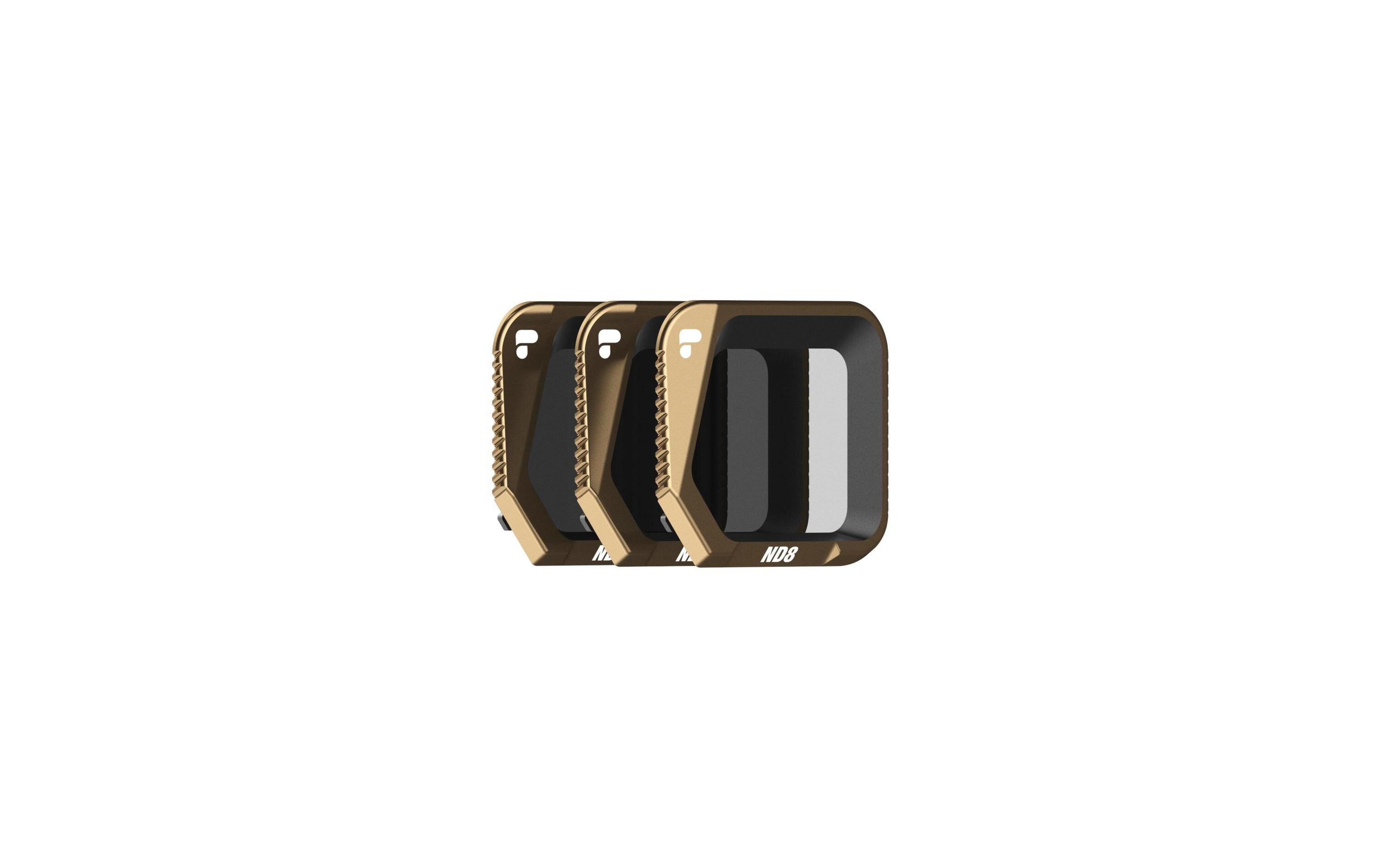 Trzy złote prostokątne filtry obiektywowe z czarnymi wkładkami, obok siebie.