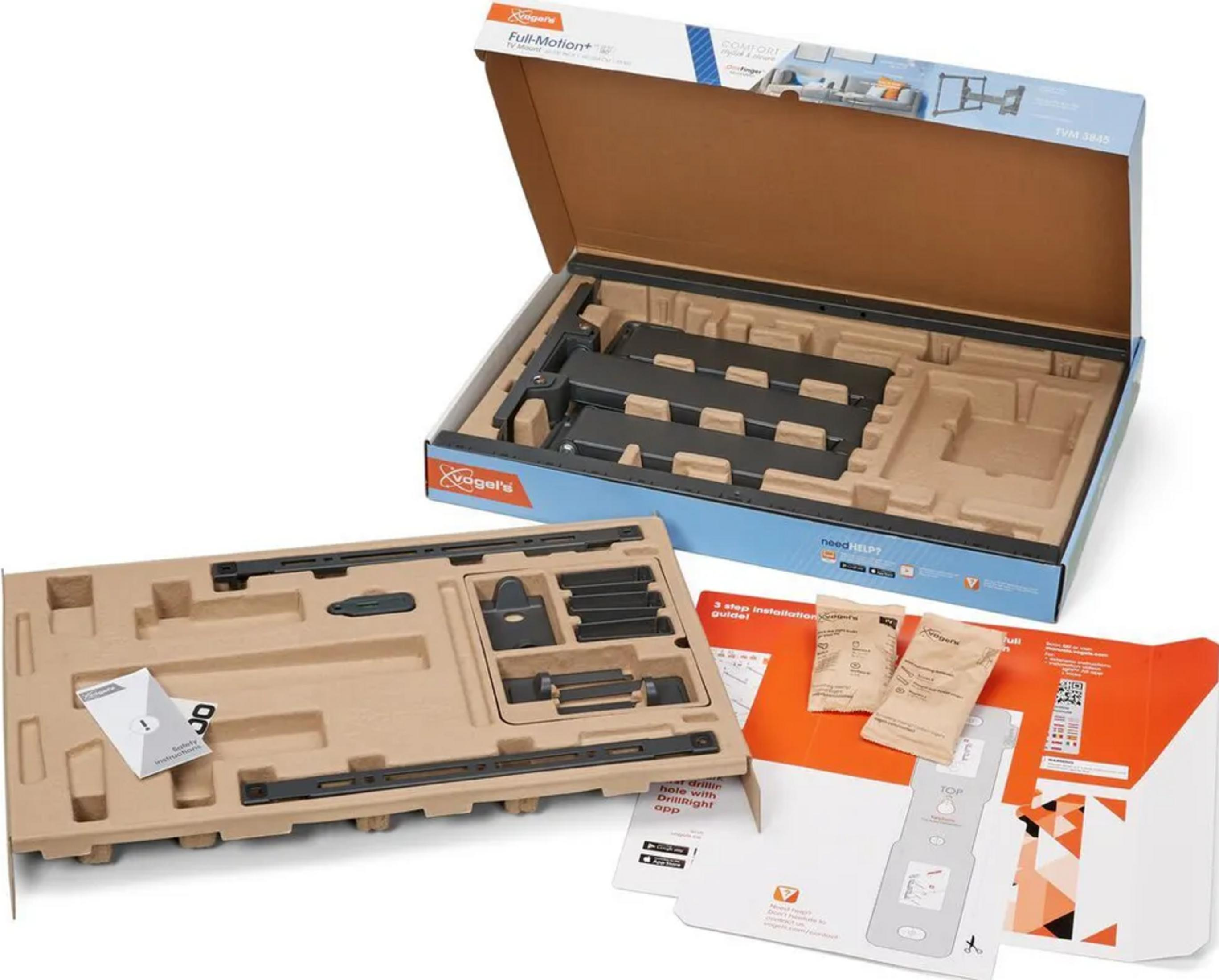 Rozpakowany uchwyt TV: części, instrukcje i akcesoria na wkładce kartonowej.
