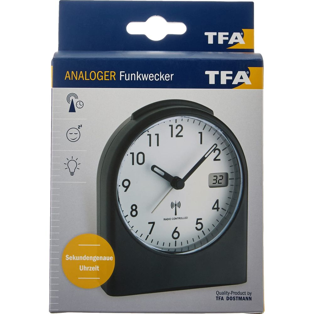 Opakowanie analogowego zegara radiowego TFA z czarną obudową i białą tarczą.