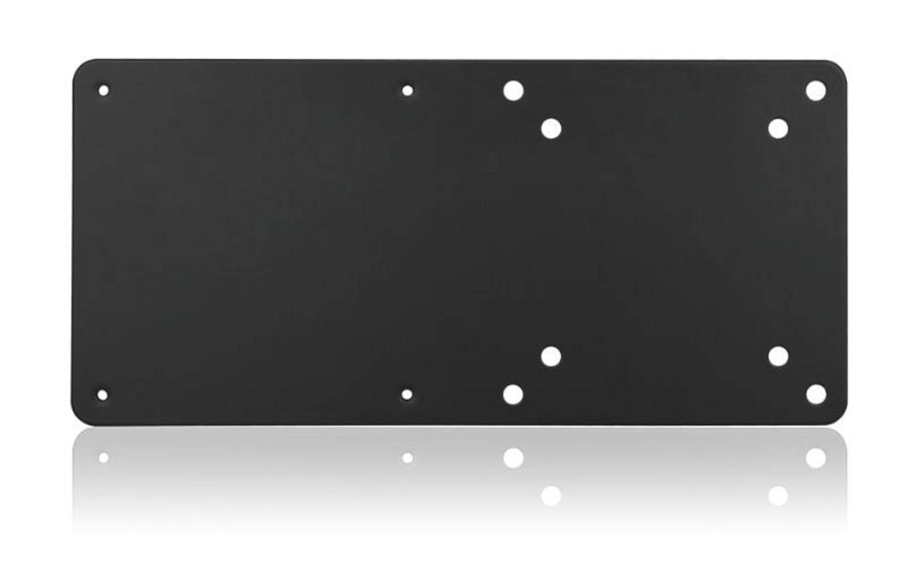 A black rectangular plate with several round holes and a reflection.