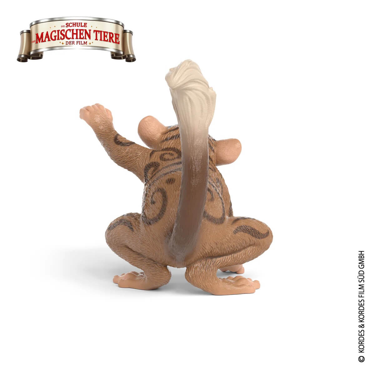 Eine braune Figur eines Affen mit Streifen, der auf allen Vieren kauert.