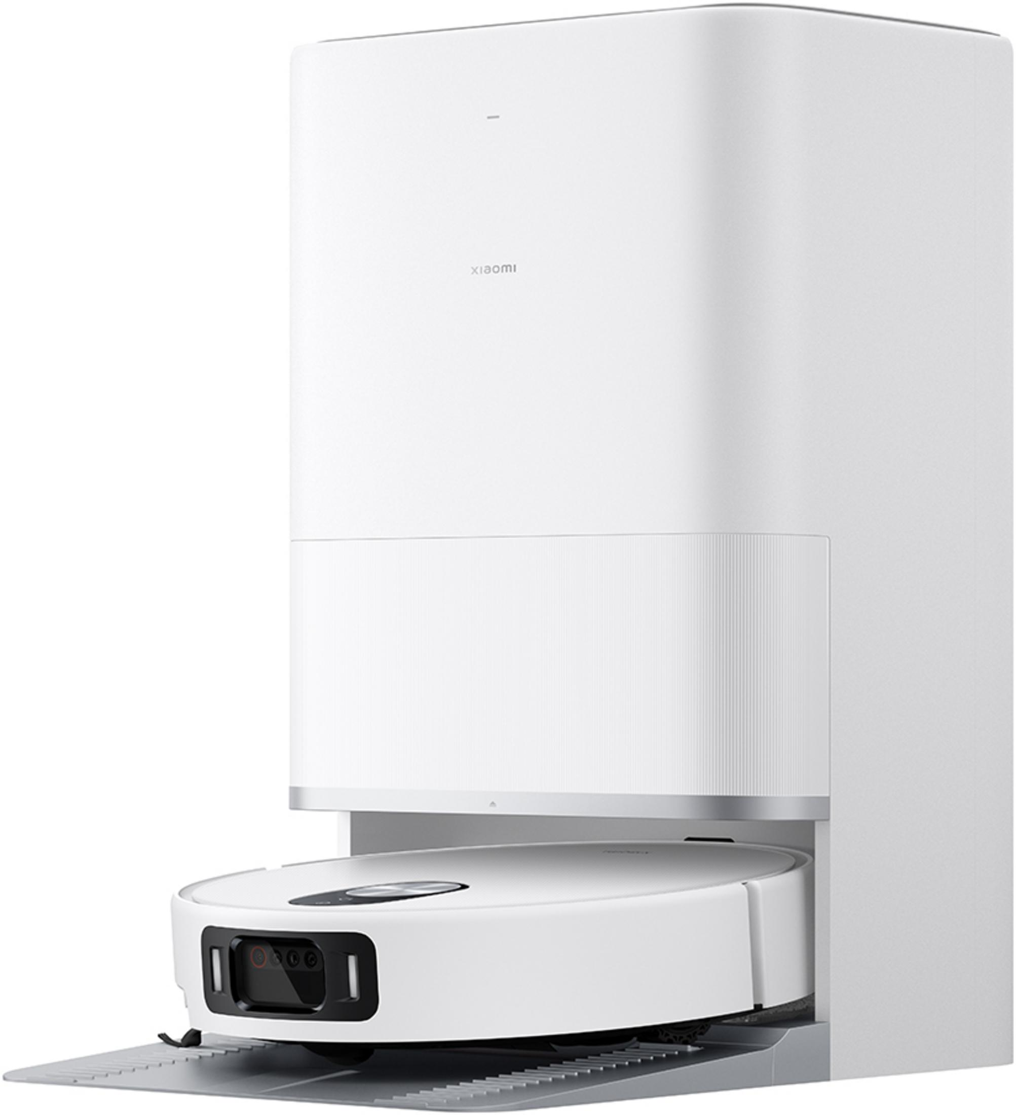 Biały robot sprzątający Xiaomi jest zadokowany w swojej stacji ładującej.