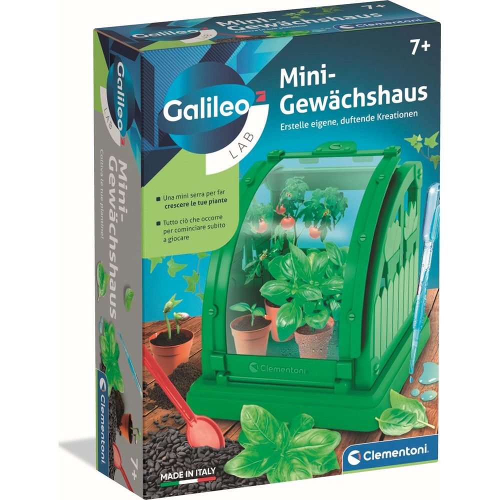 Ein grünes Mini-Gewächshaus-Spielzeug mit Pflanzen und Zubehör auf einem Holztisch.
