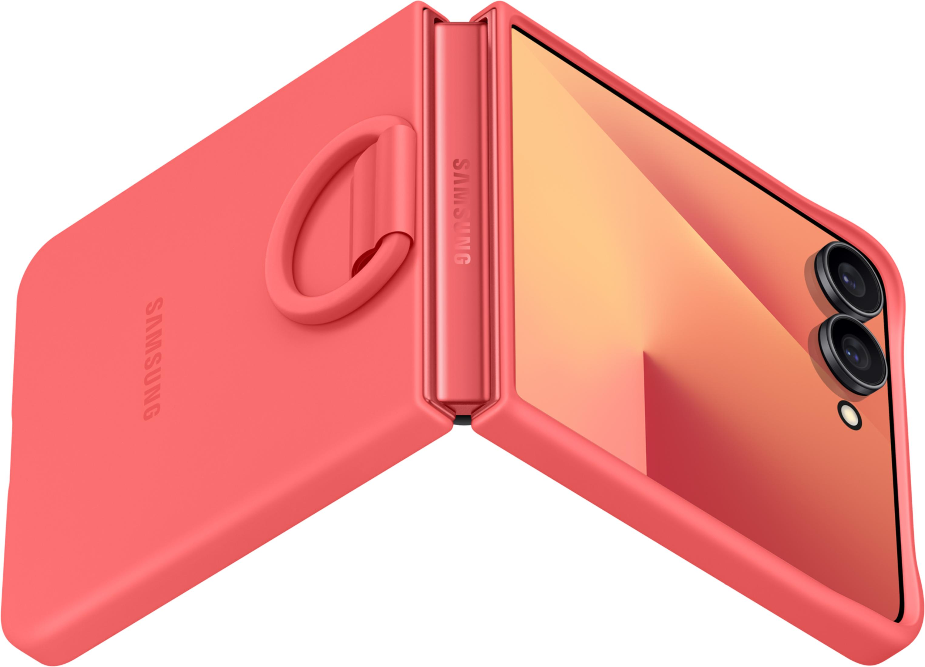 Koralowy telefon składany z logo Samsung, otwarty, widoczne aparaty.