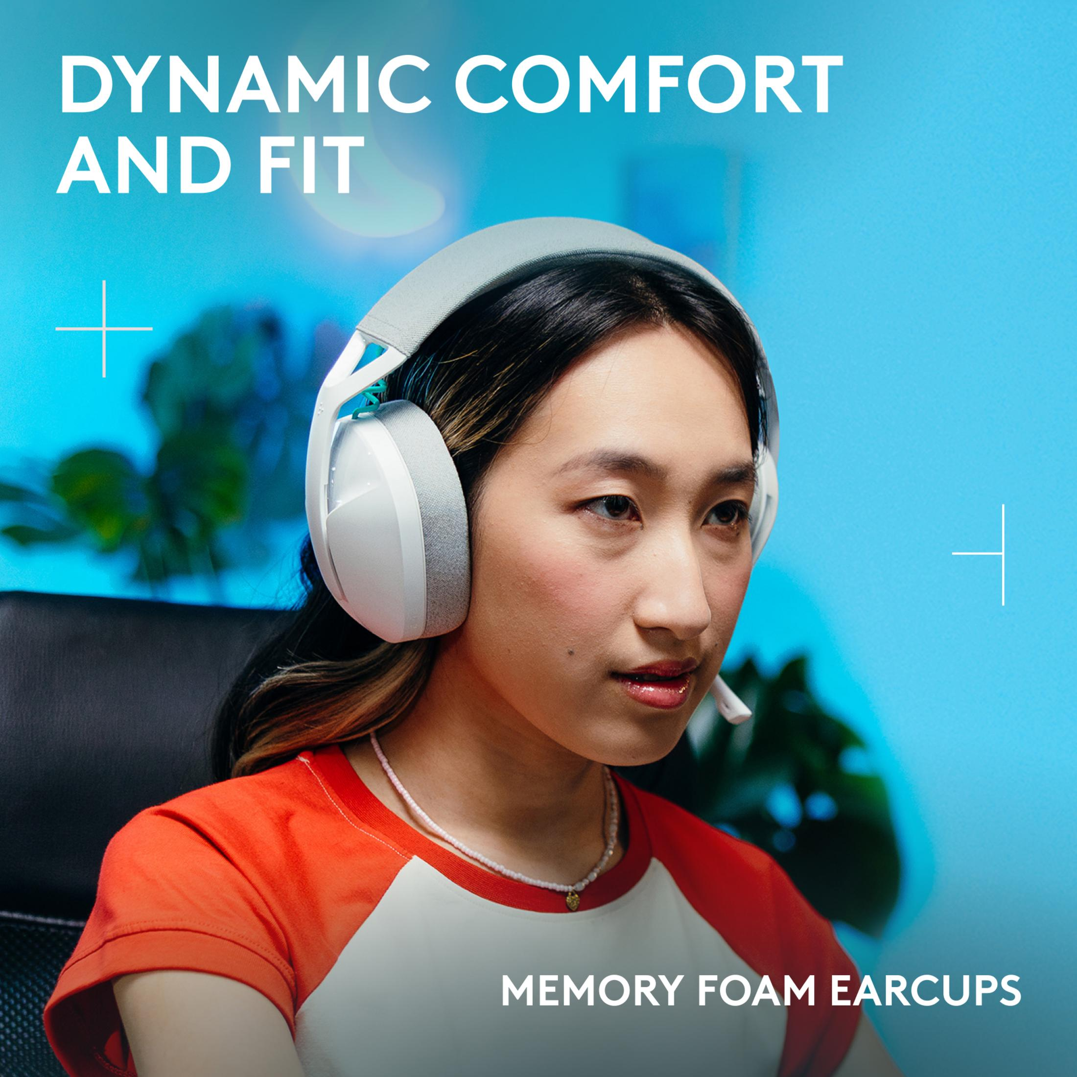Young woman wearing headphones and a red shirt against a blue background.