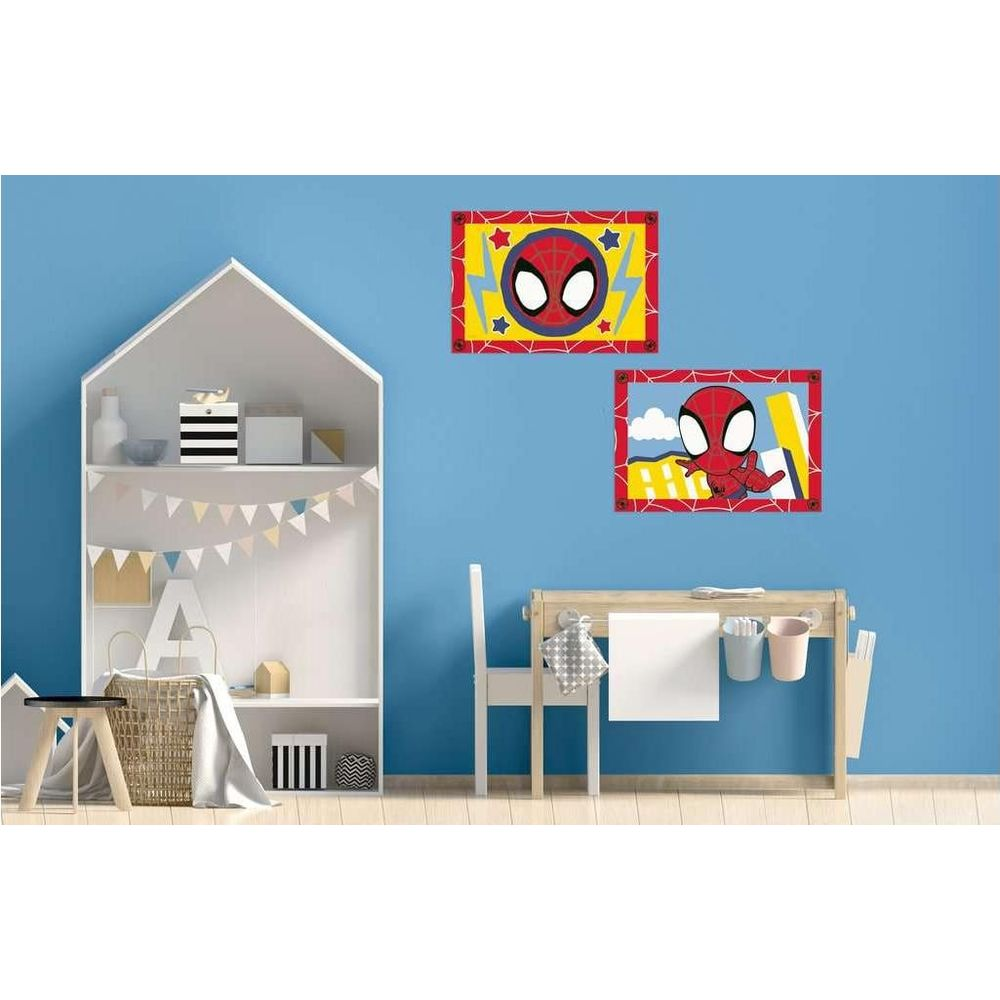 Habitación infantil con pared azul, estantería blanca, escritorio y cuadros de Spiderman.