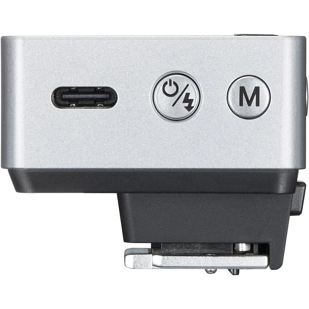 Appareil argenté avec USB-C, icône Marche/Flash et bouton M.