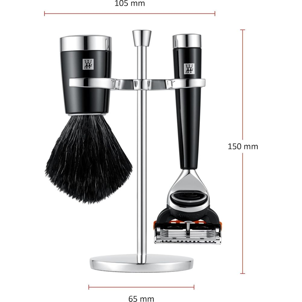 Un set da barba con pennello nero e rasoio su un supporto d'argento.