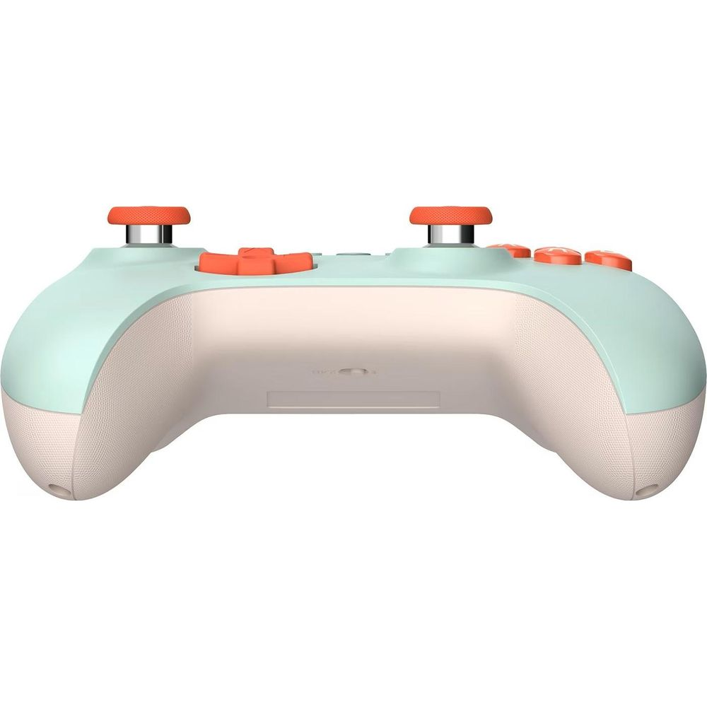 Miętowo-kremowy kontroler do gier z pomarańczowymi przyciskami i joystickami.