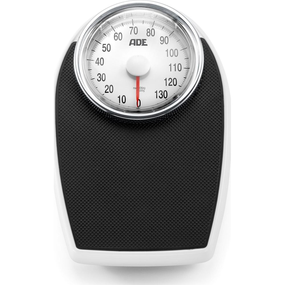 Biało-czarna waga analogowa z okrągłą tarczą. Wskaźnik wskazuje 0 kg.