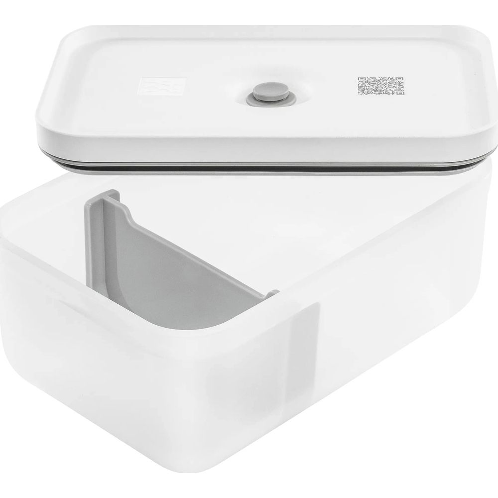 Un contenitore bianco con inserto grigio e coperchio staccato.