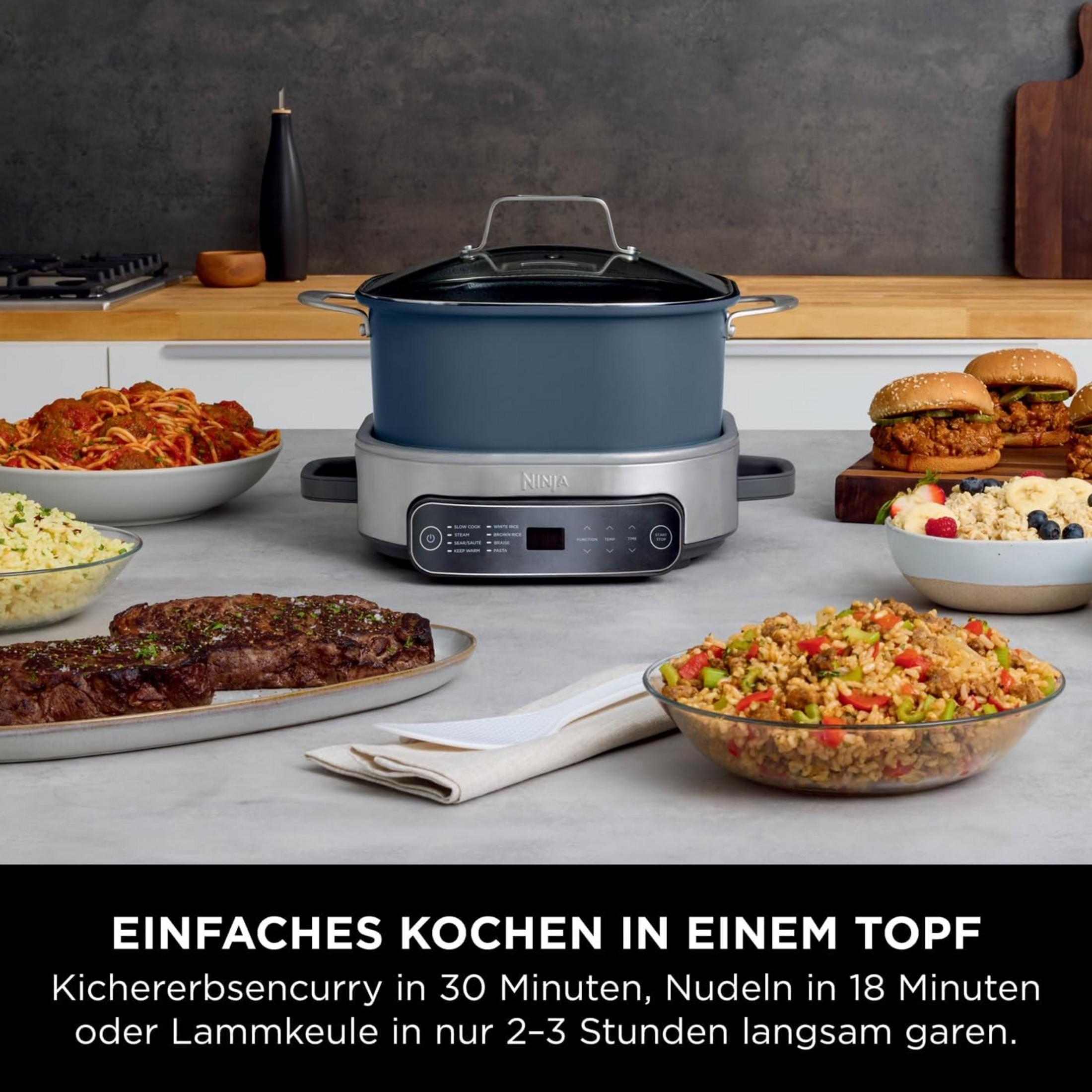A Ninja cooker with various dishes like meat, pasta, and rice.