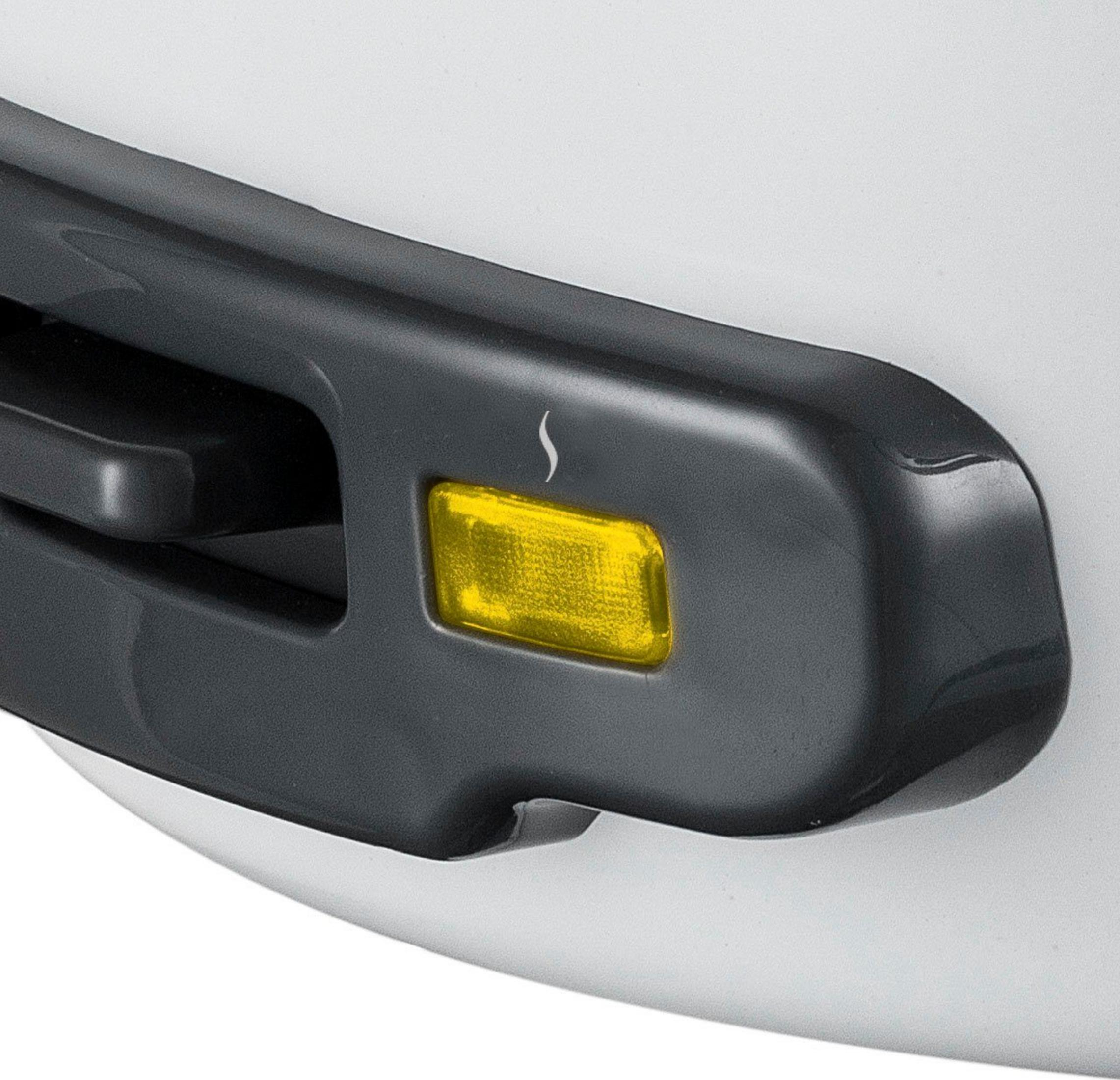 Żółta lampka kontrolna z symbolem pary na ciemnym uchwycie.