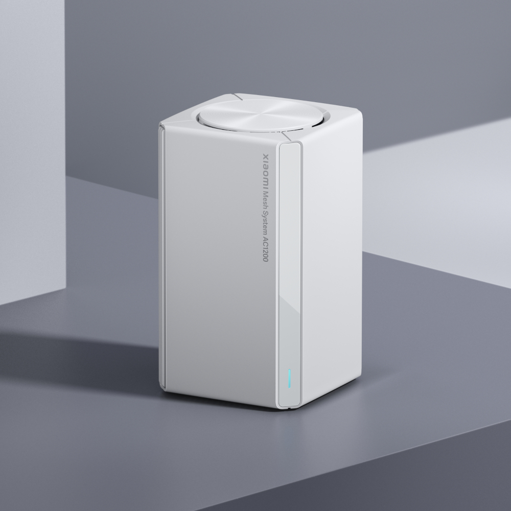 Un router bianco Xiaomi Mesh System AC1200 su una superficie grigia.
