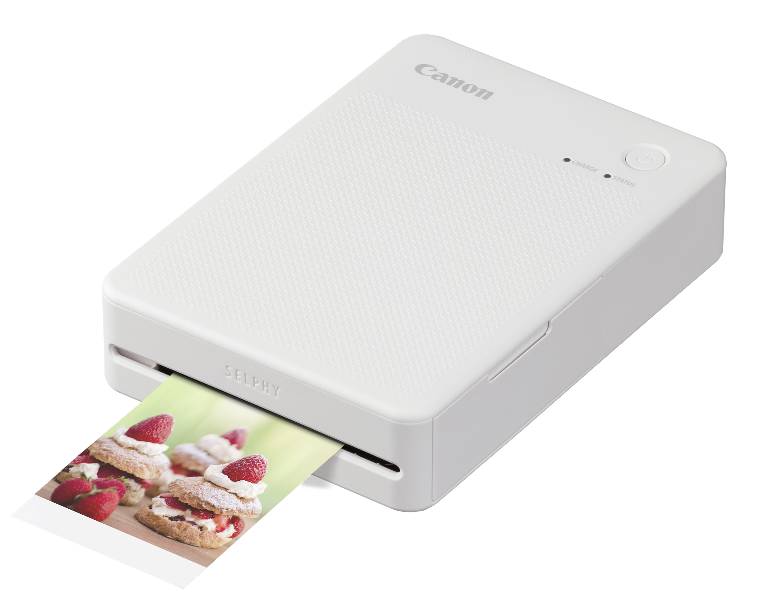 Una impresora Canon Selphy blanca imprime una imagen de pasteles de fresa con crema.