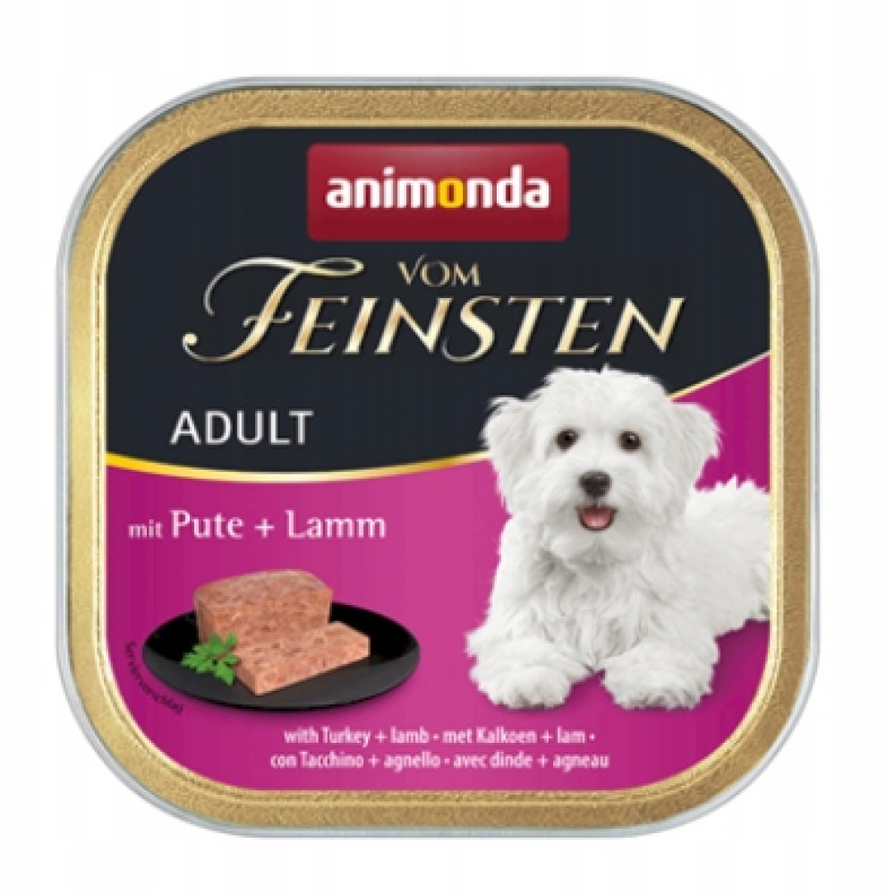 Animonda karma dla psów z indykiem i jagnięciną, z białym psem i dwiema kostkami mięsa.