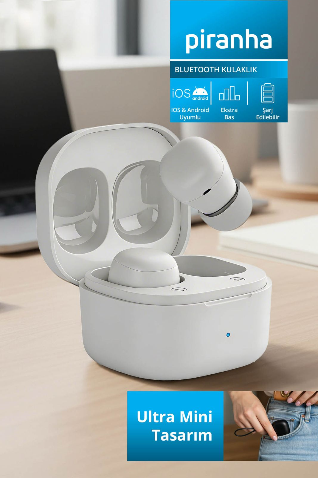 Beyaz Piranha Bluetooth kulaklık ve şarj kutusu, arkada dizüstü bilgisayar.