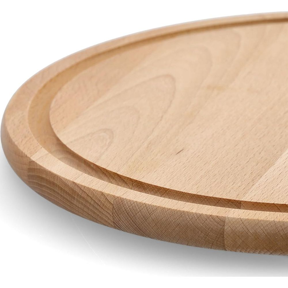 Primo piano di un tagliere rotondo in legno con scanalatura circostante.