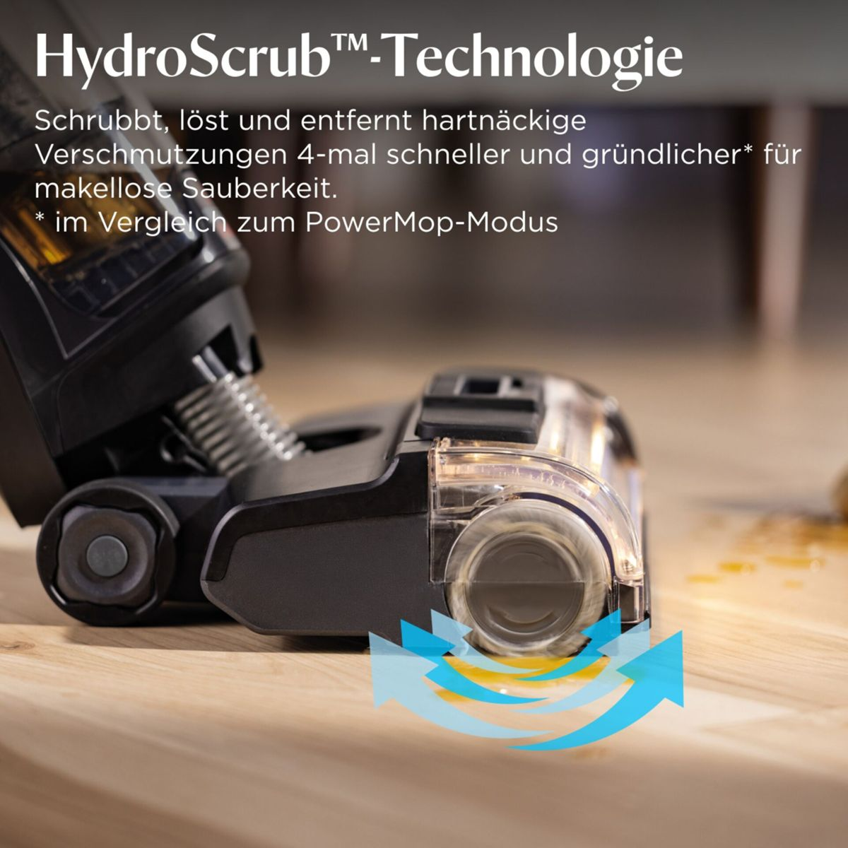Nahaufnahme eines Staubsaugerkopfs mit HydroScrub-Technologie auf einem Holzboden.