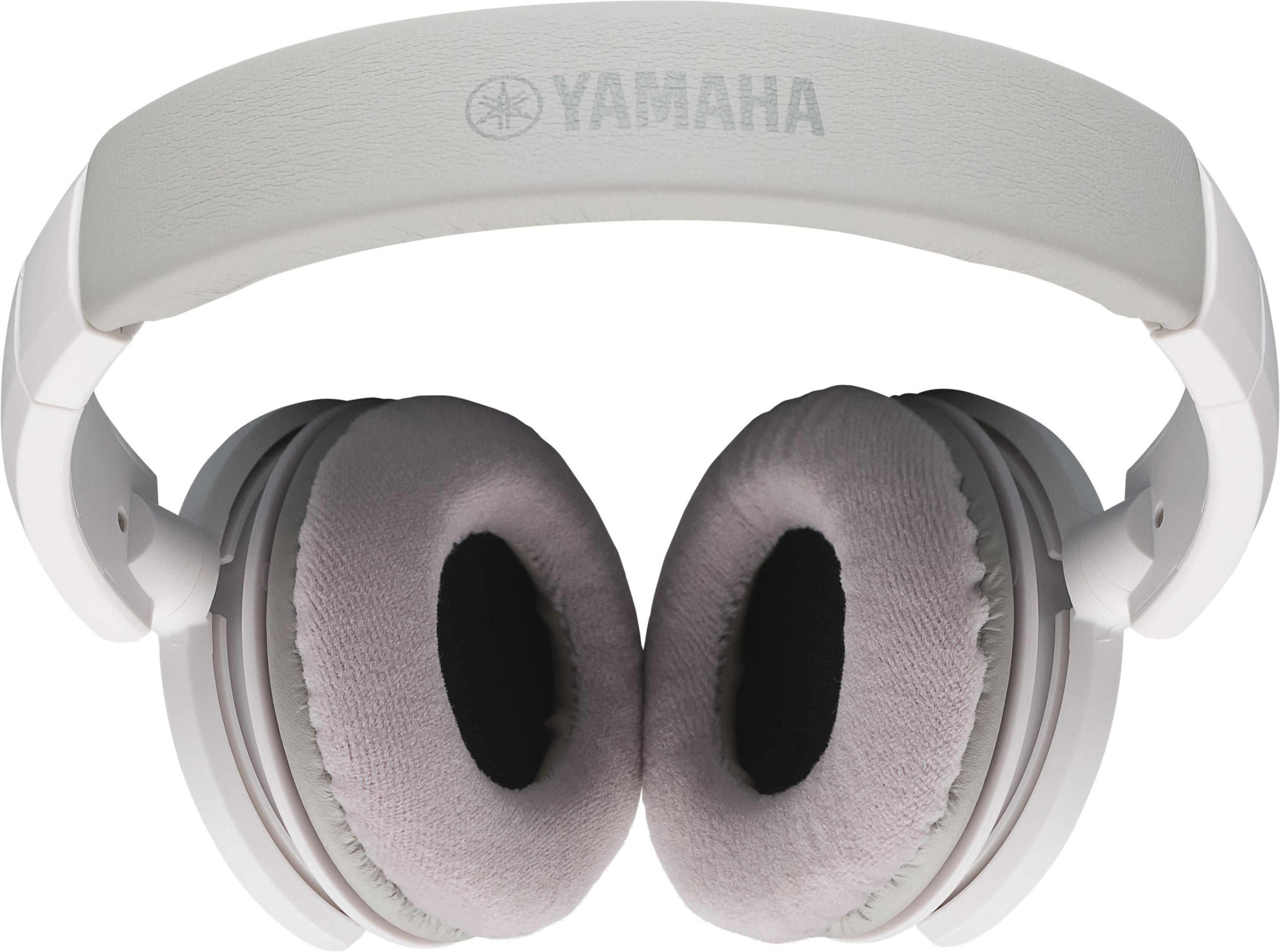 Casque Yamaha blanc avec oreillettes rembourrées et bandeau réglable.