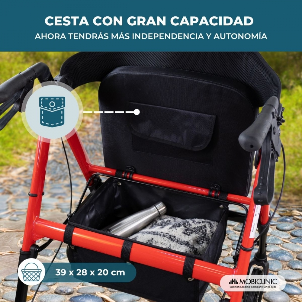 Un andador rojo con una gran cesta negra que contiene una botella y una manta.