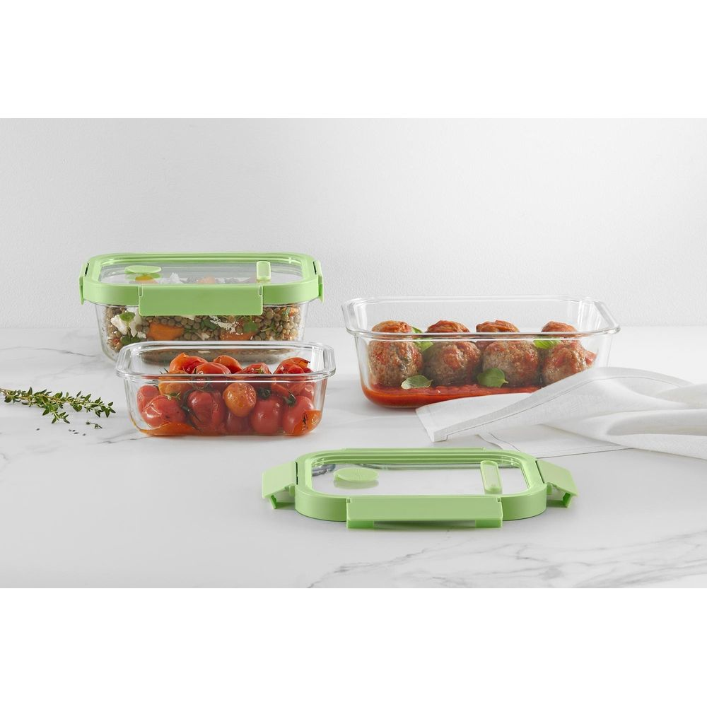 Tre contenitori in vetro con cibo: lenticchie, pomodori e polpette.