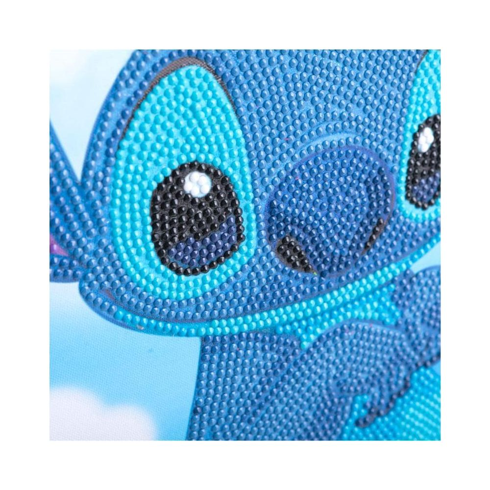 Ein blauer Stitch-Charakter aus Diamant-Kunst mit großen Augen und einem breiten Lächeln.