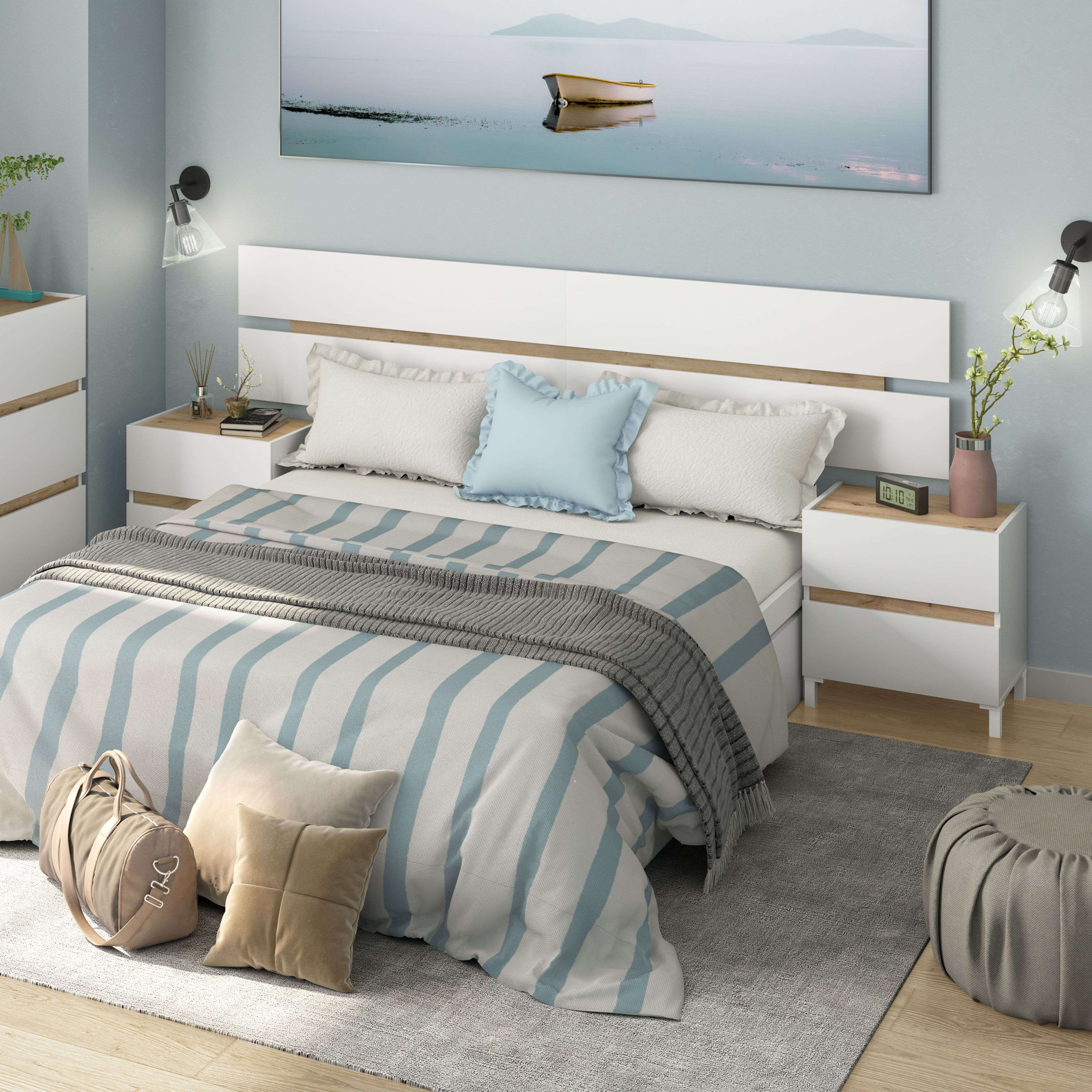 Un dormitorio con ropa de cama a rayas, cojines, un bolso de lona y un puf.