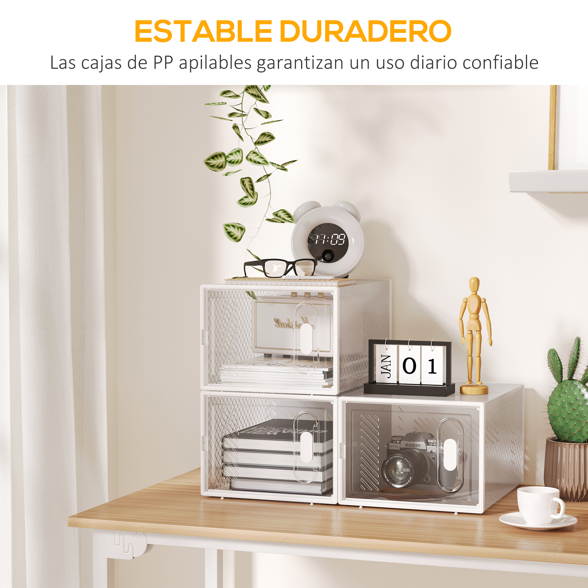 Un escritorio con cajas de almacenamiento blancas, libros, cámara y cactus.