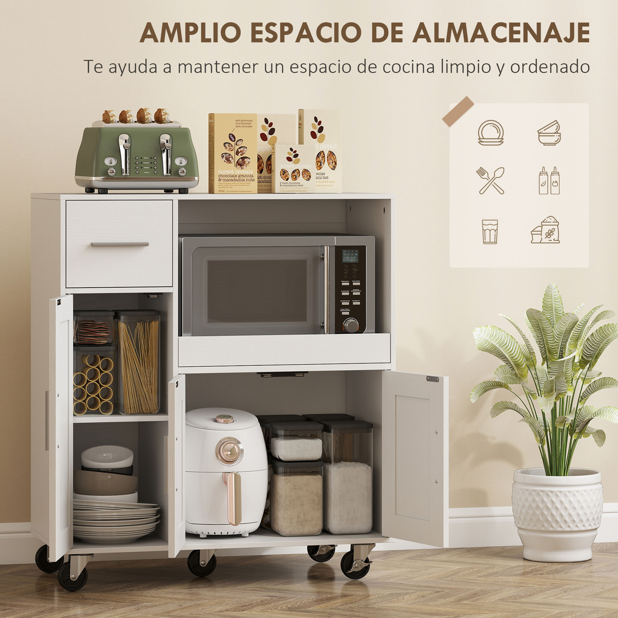 Un carrito de cocina blanco con tostadora, microondas, freidora de aire, platos y planta.