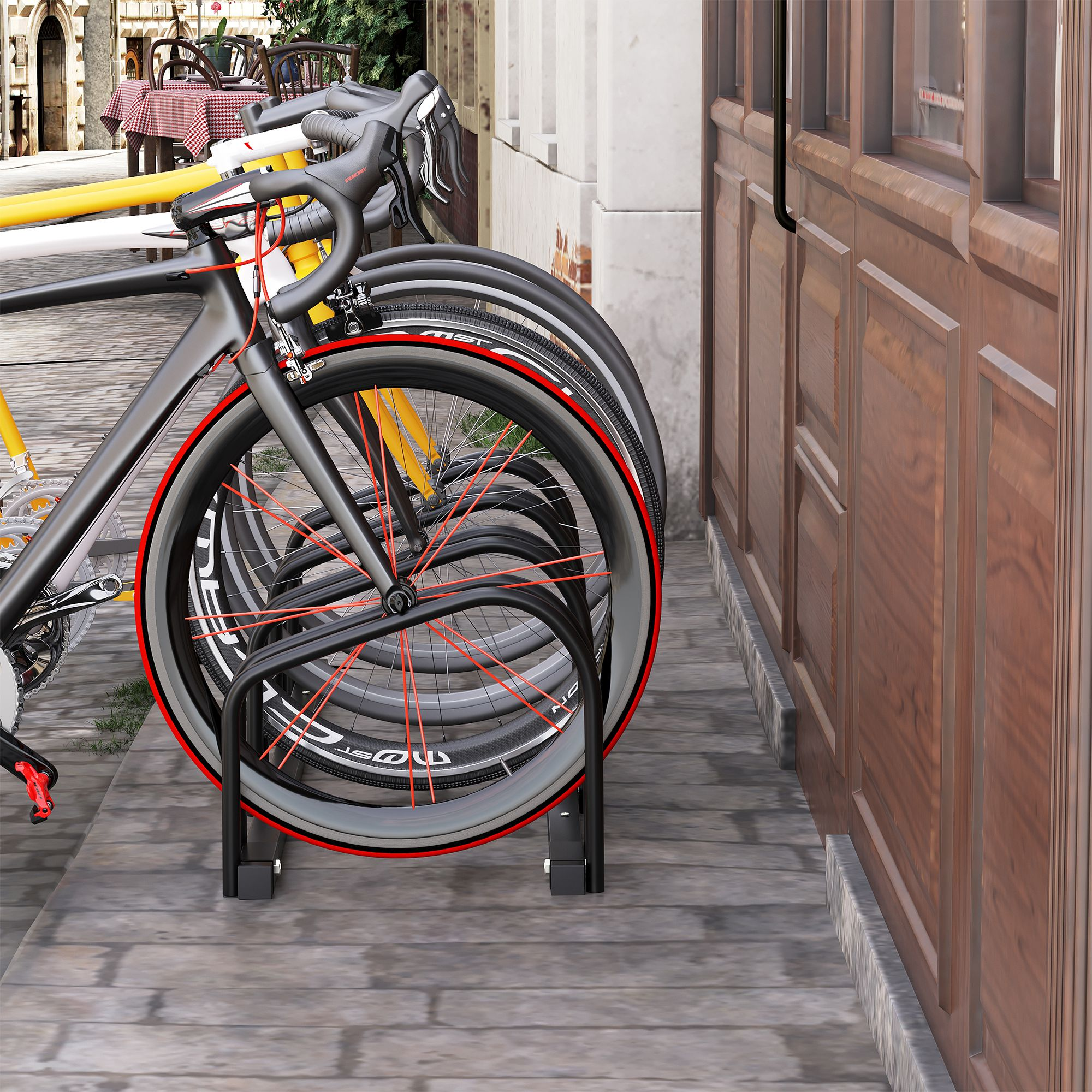 Varias bicicletas aparcadas en un soporte, con radios y llantas rojas.