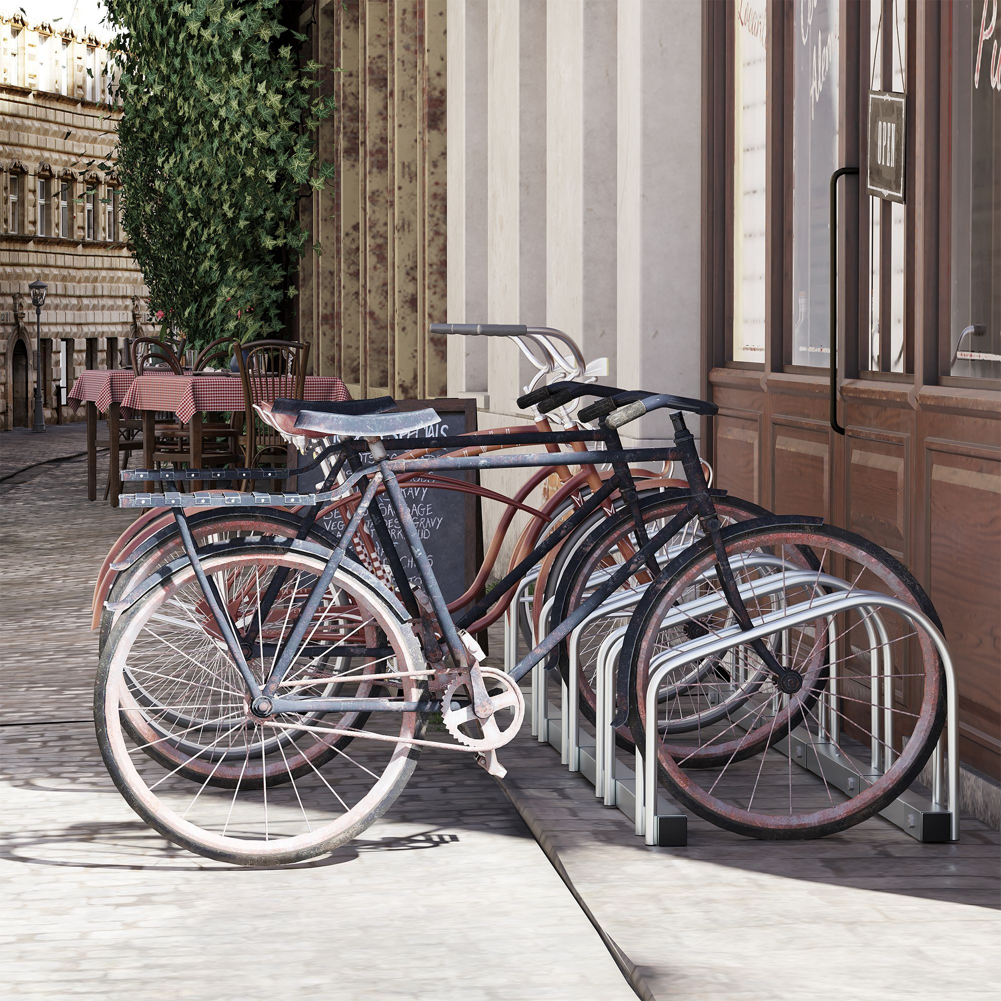 Varias bicicletas aparcadas en un aparcamiento frente a una cafetería con asientos al aire libre.