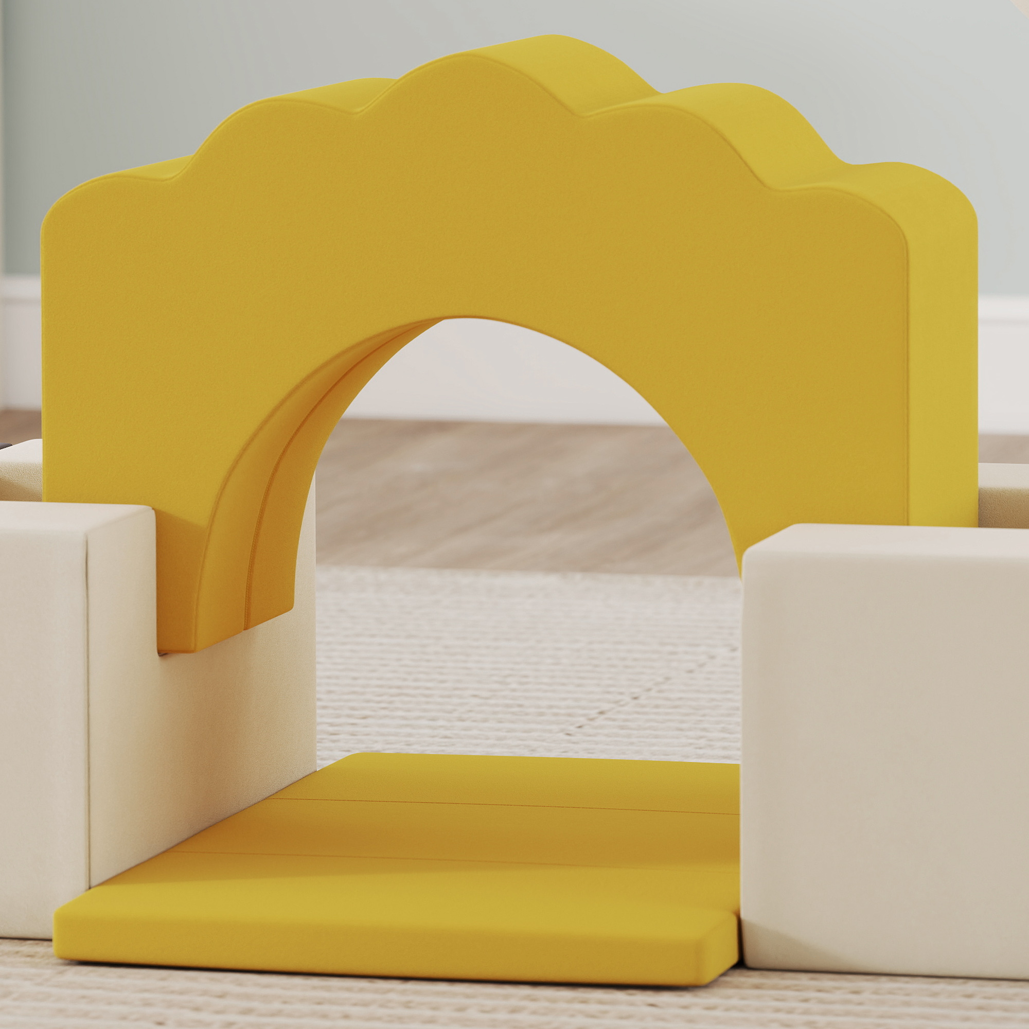 Estructura de escalada amarilla con un arco sobre una alfombra.