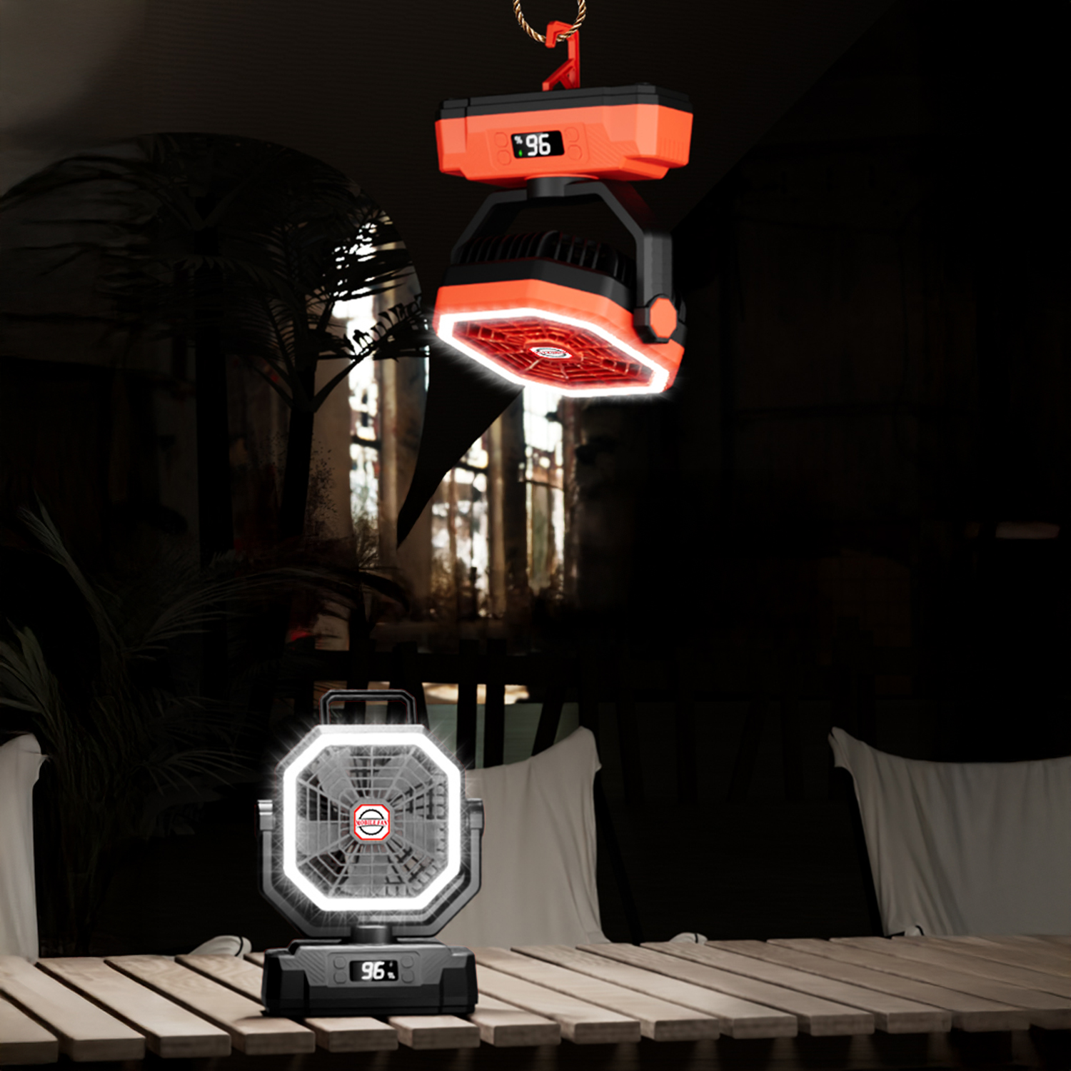 Ventilador colgante naranja con luz sobre un ventilador de mesa en mesa de madera.
