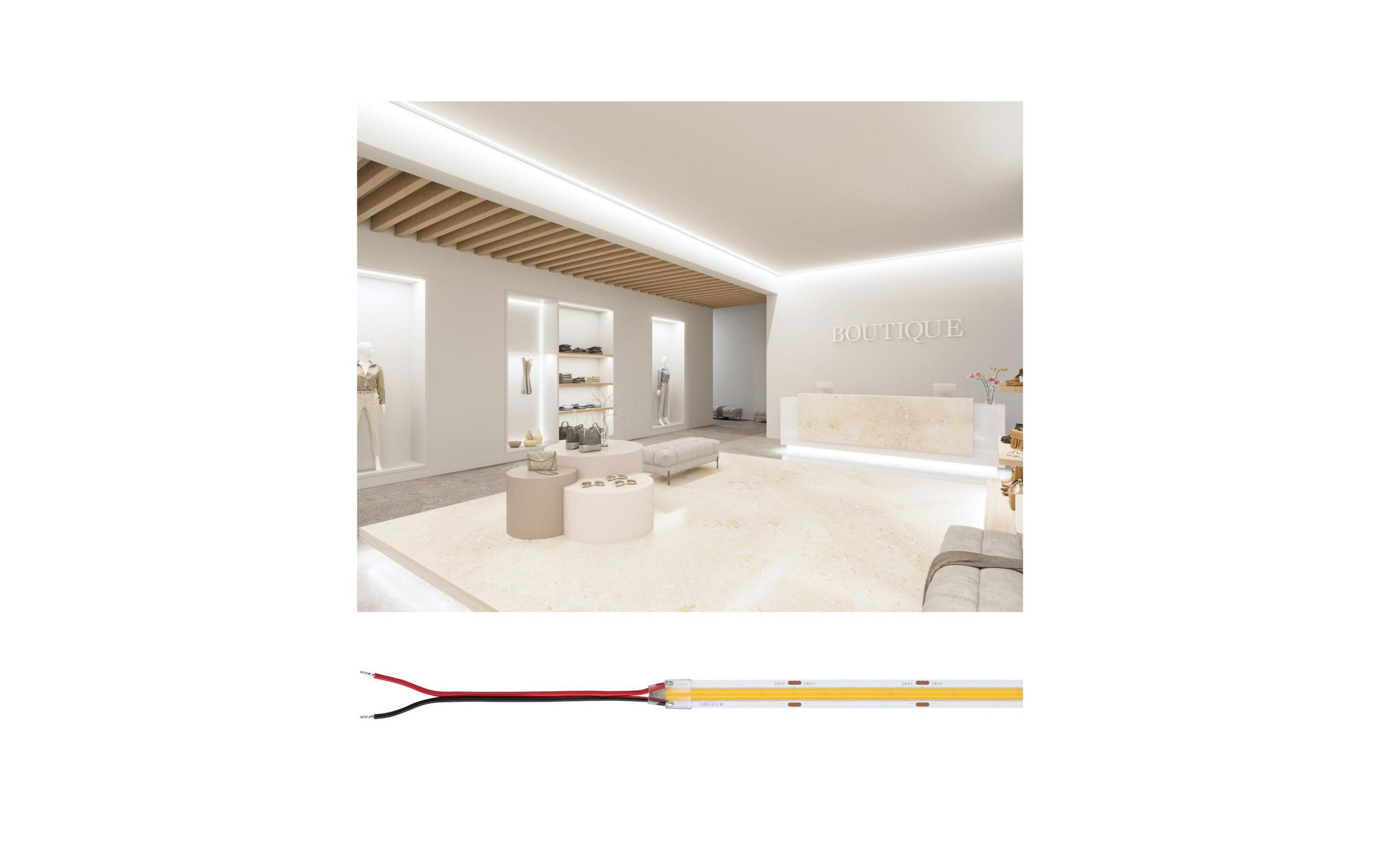 Wnętrze butiku z recepcją, witrynami i miejscami do siedzenia.