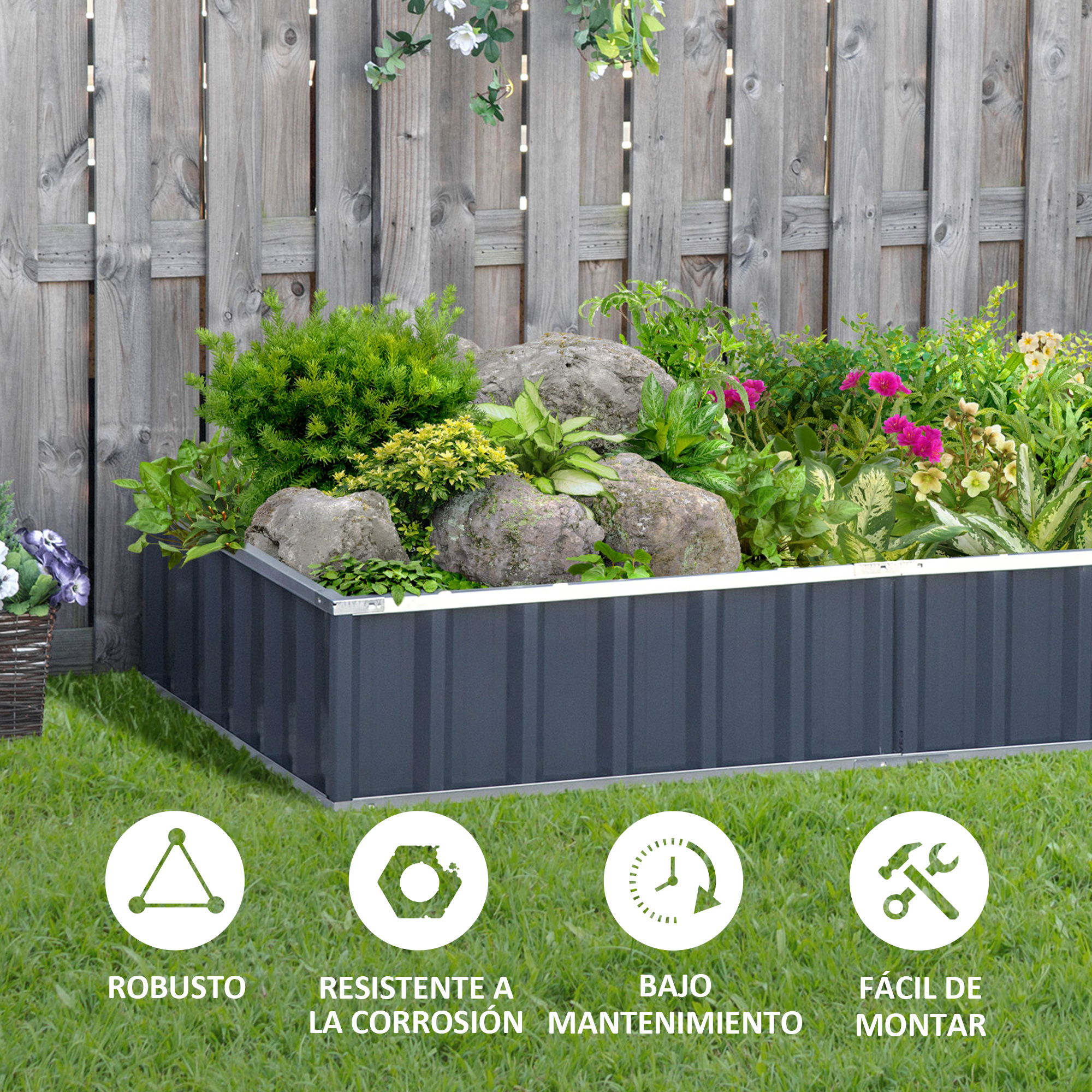 Un bancal elevado gris con plantas y rocas sobre césped.
