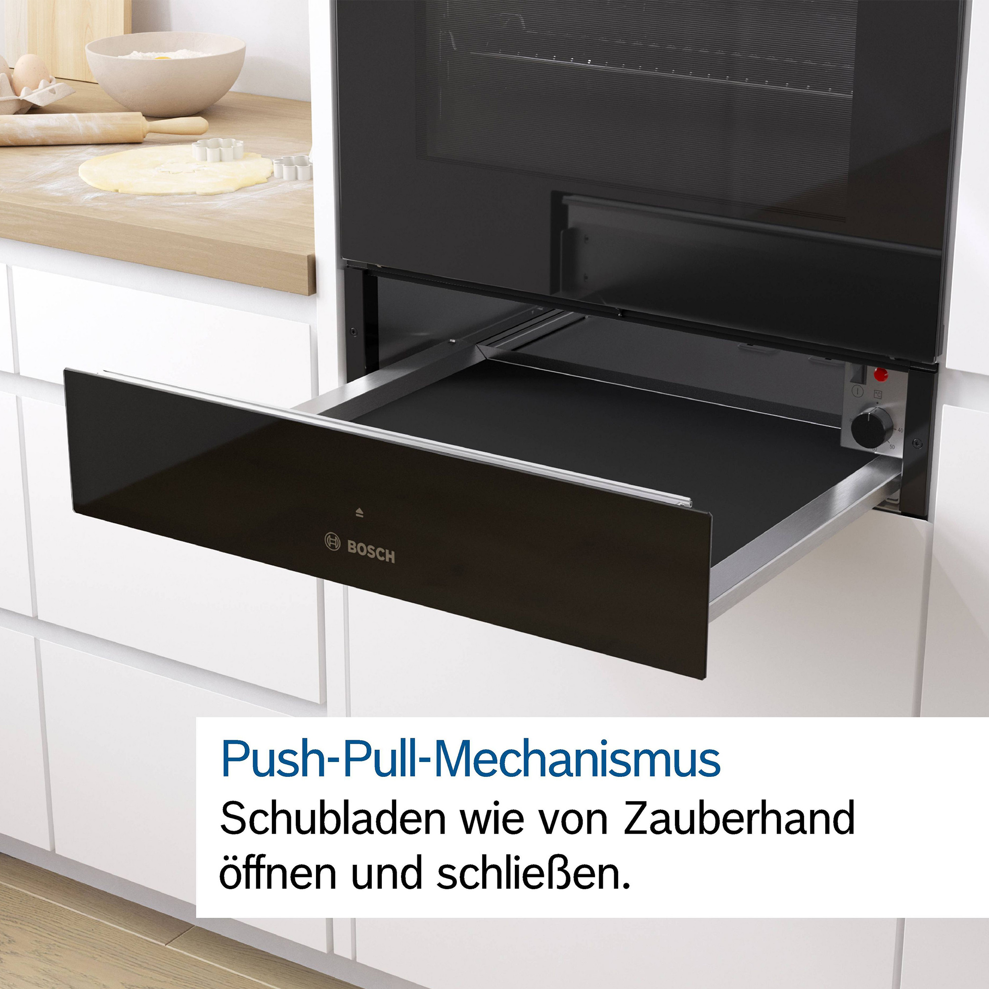 Un tiroir extractible avec logo Bosch, à côté de la porte d'un four.