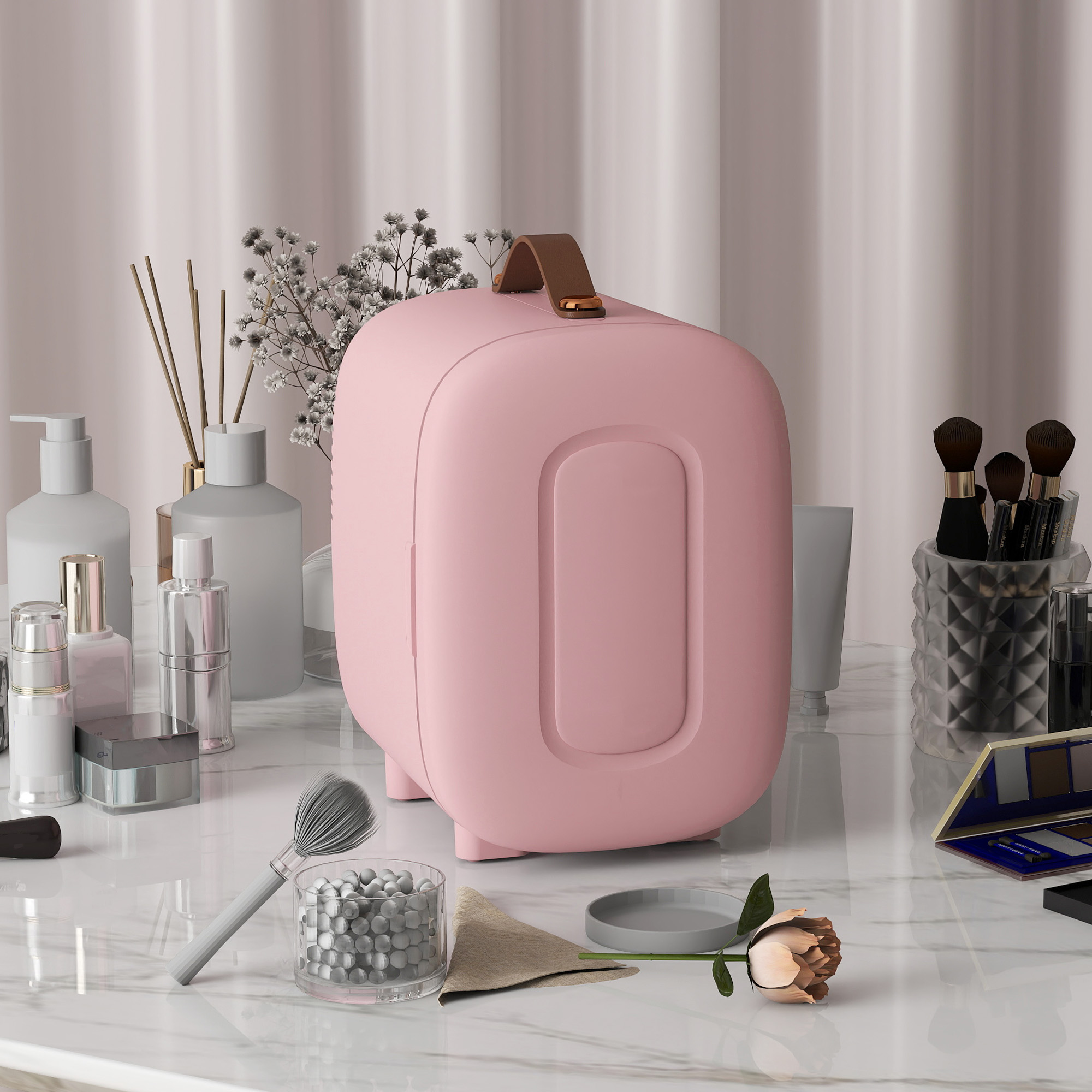 Un refrigerador de cosméticos rosa sobre un mostrador de mármol con maquillaje y flores.