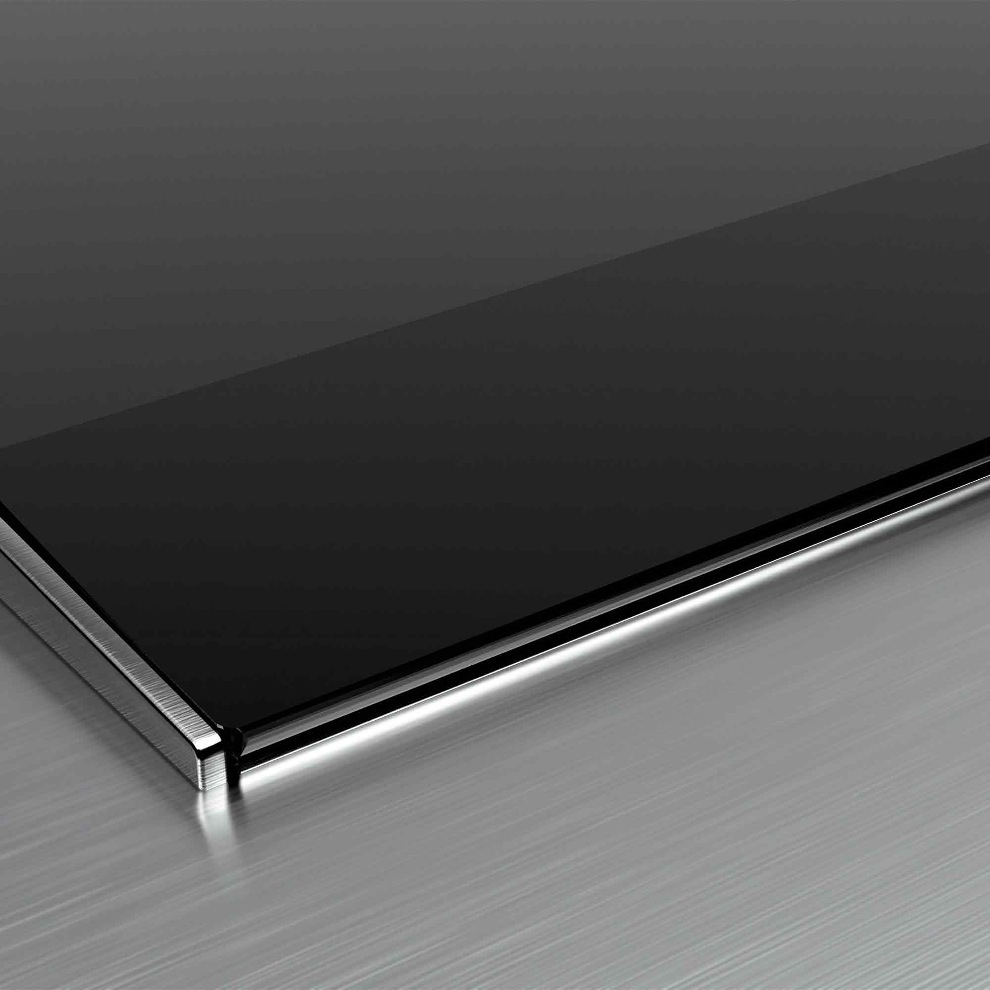 Czarna szklana powierzchnia z polerowaną metalową krawędzią na szczotkowanej podstawie metalowej.