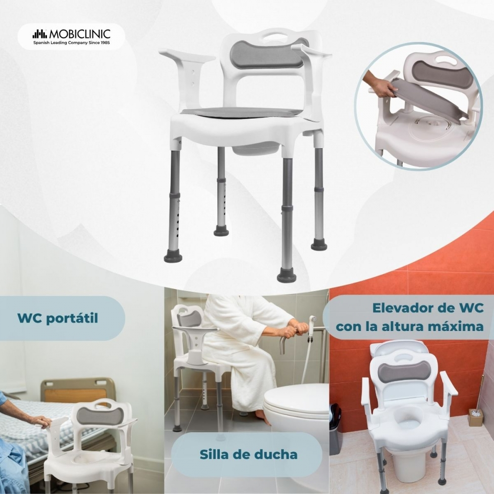 Silla de ducha blanca con patas y reposabrazos ajustables, junto a un asiento de inodoro y cama.